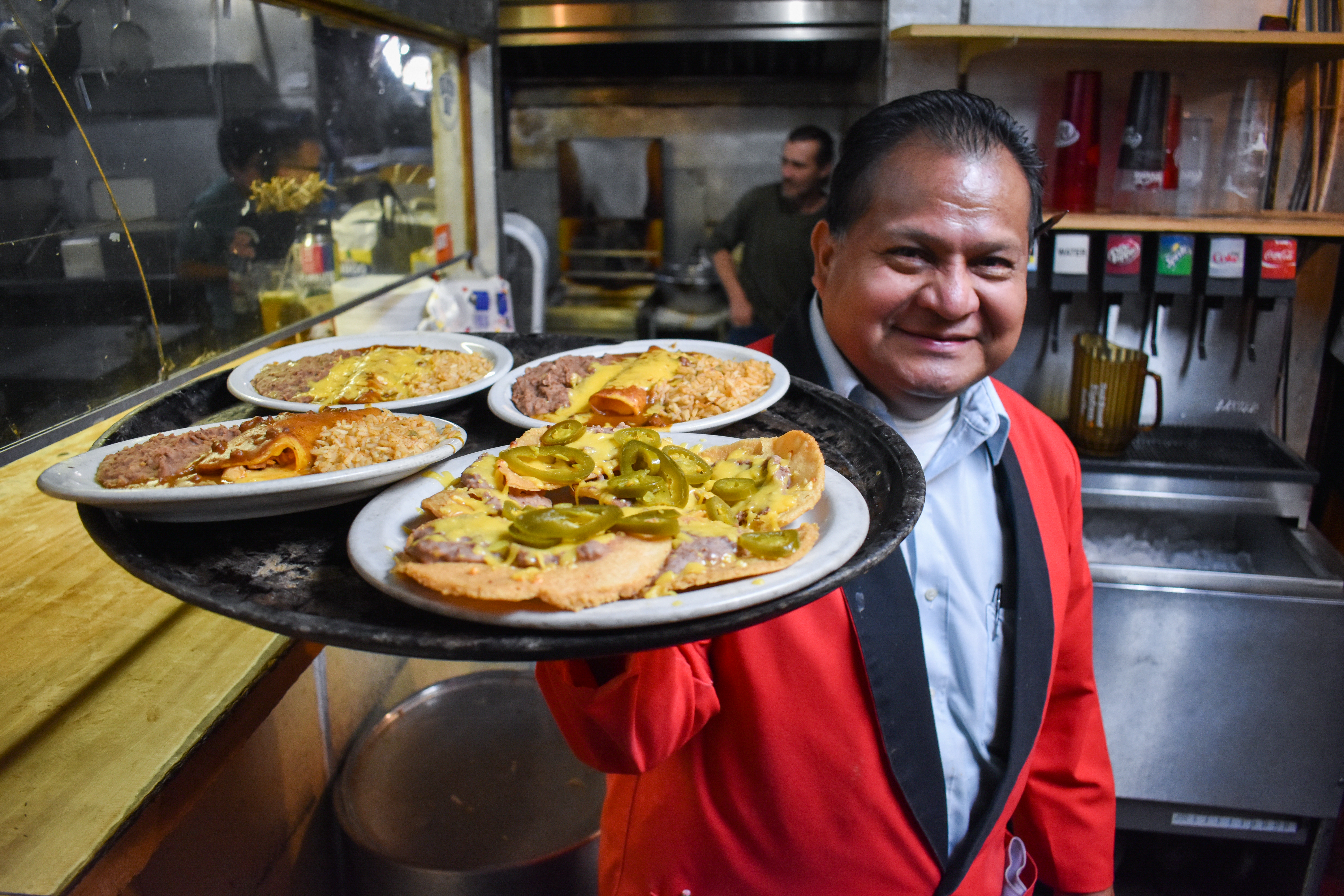 Longtime El Patio waiter Jaime Arriola with a platter of food
