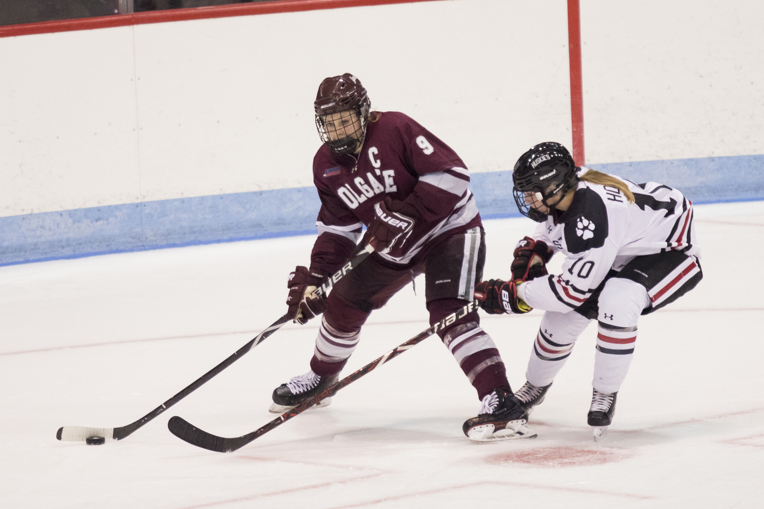 Northeastern defender Brooke Hobson defends Colgate forward Jessie Eldridge during an NCAA game at Matthews Arena in Boston, MA on Oct. 12, 2018. (Photo by Michelle Jay)