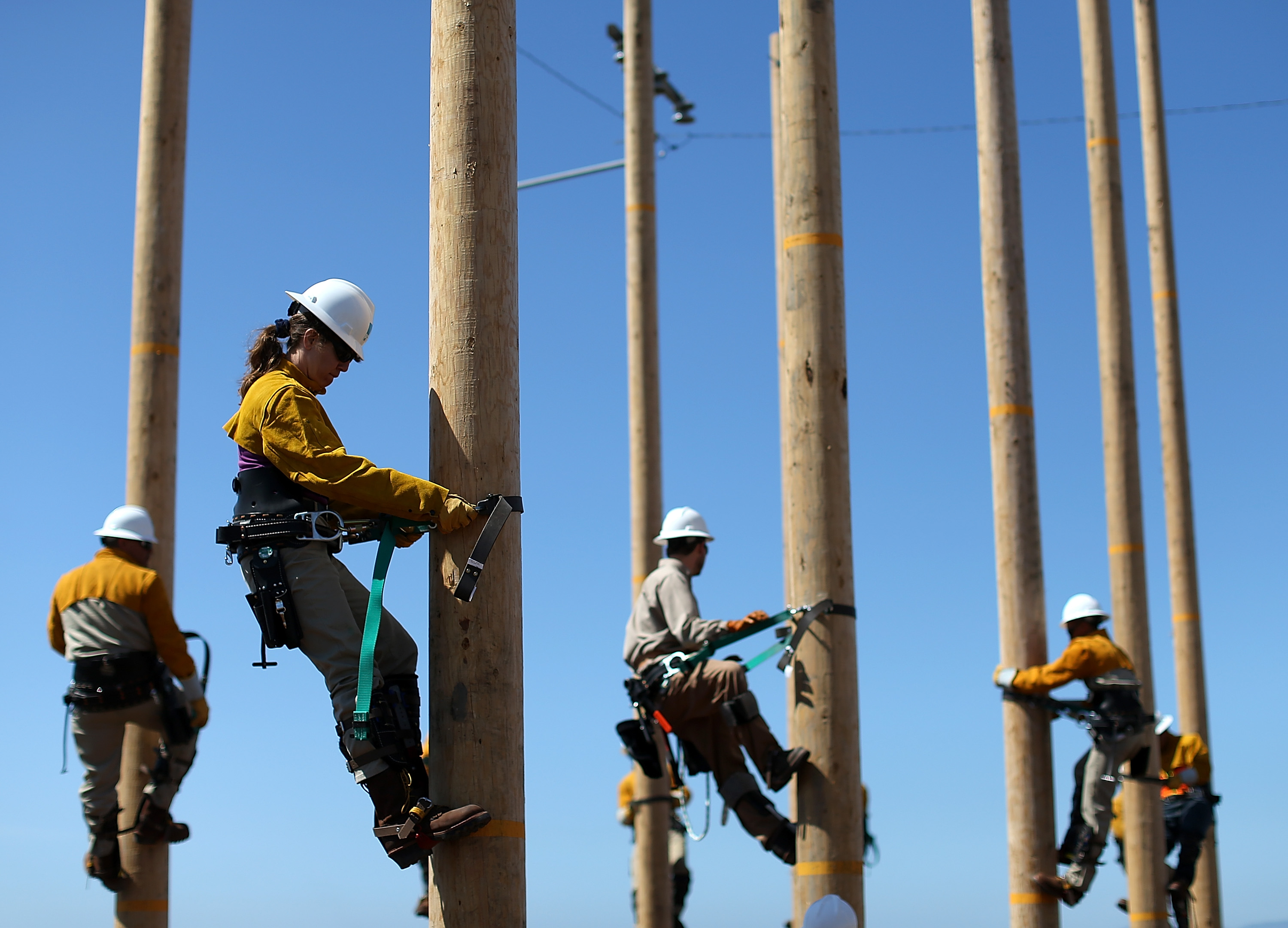 Utility Worker Trainees Learn Pole-Climbing Skills