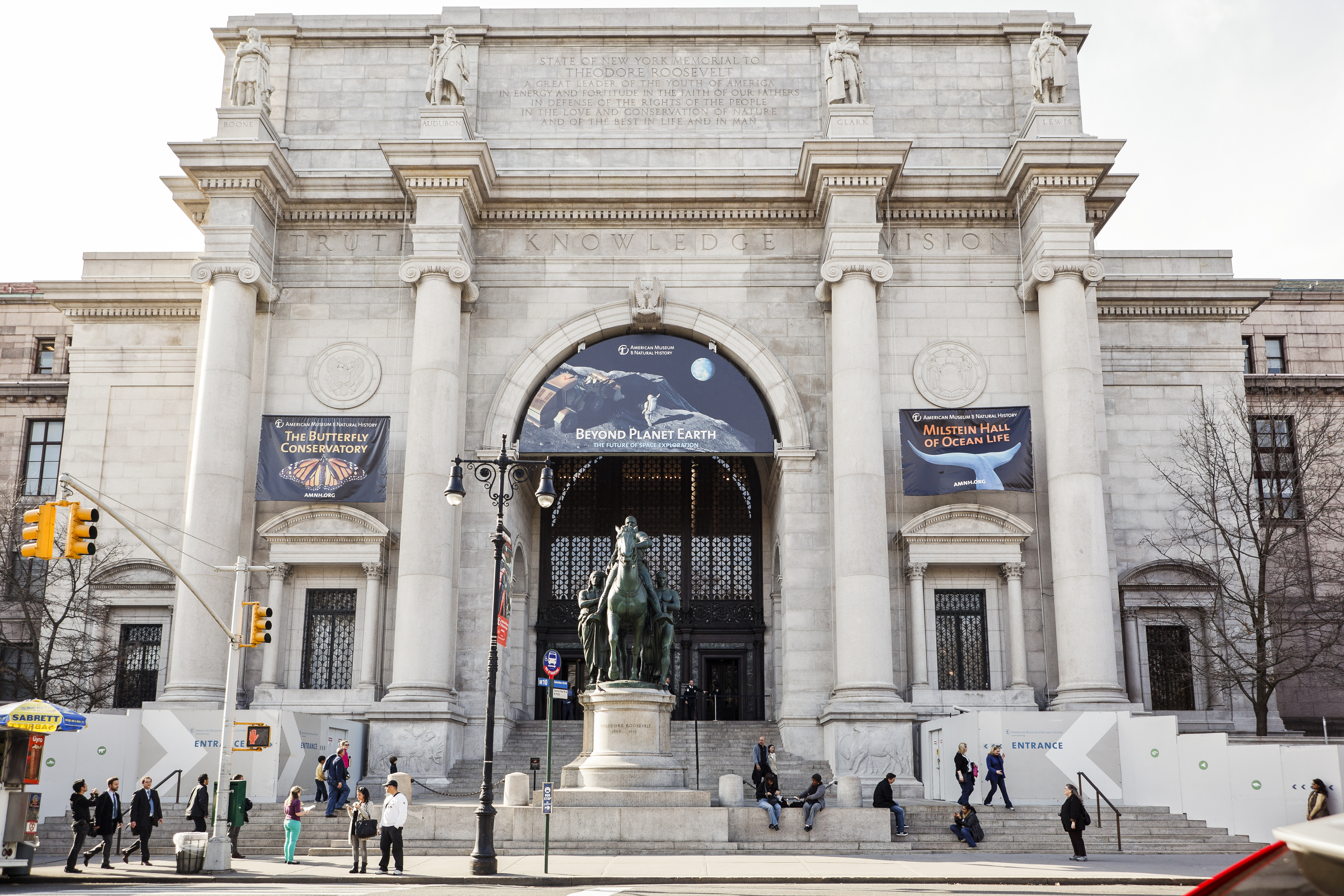 The exterior of the American Museum of Natural History. The facade is white with columns. 