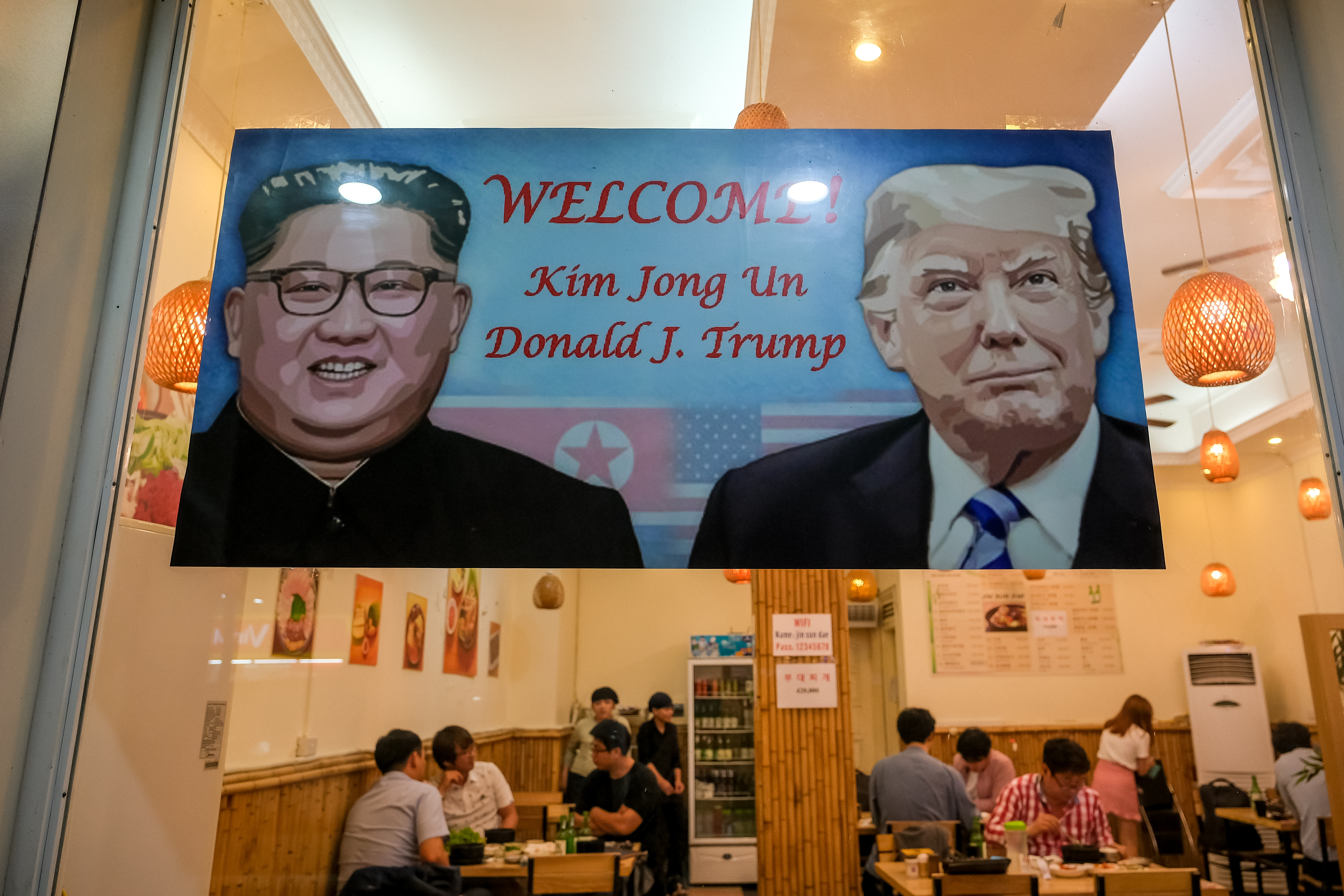 A signboard welcomes the upcoming summit between President Donald Trump and North Korean leader Kim Jong Un at South Korean restaurant on February 20, 2019, in Hanoi, Vietnam.