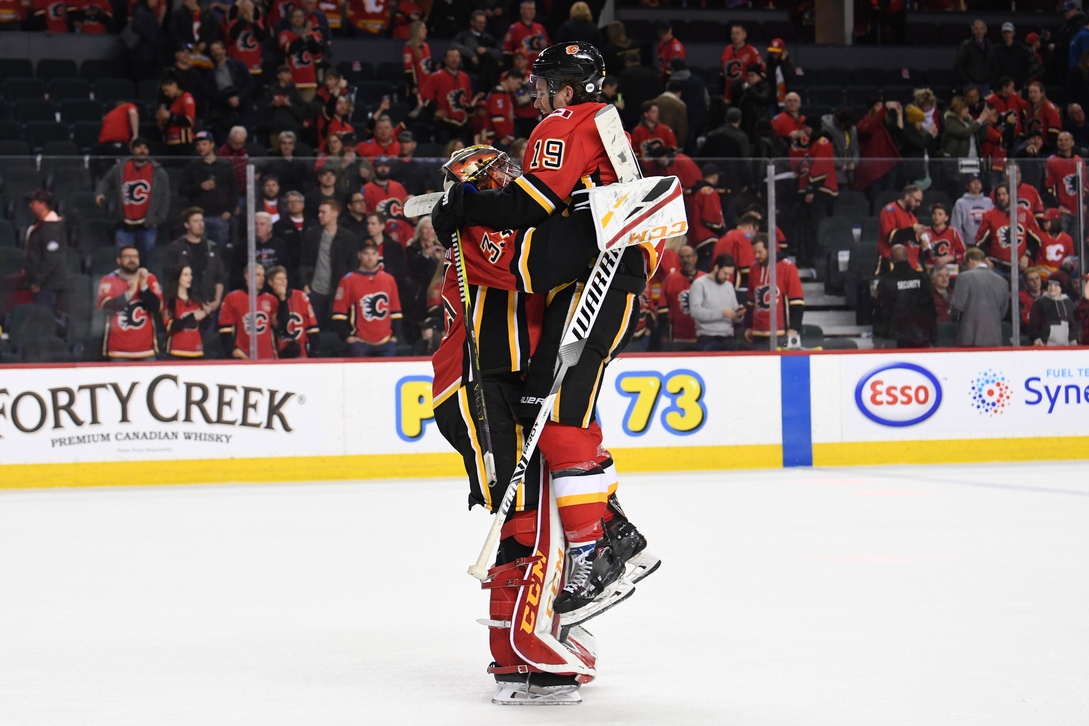 Mar 10, 2019; Calgary, Alberta, CAN; Calgary Flames goalie David Rittich (33) and left wing Matthew Tkachuk (19) celebrate the win over the Las Vegas Golden Knights at Scotiabank Saddledome. Flames won 6-3.&nbsp;