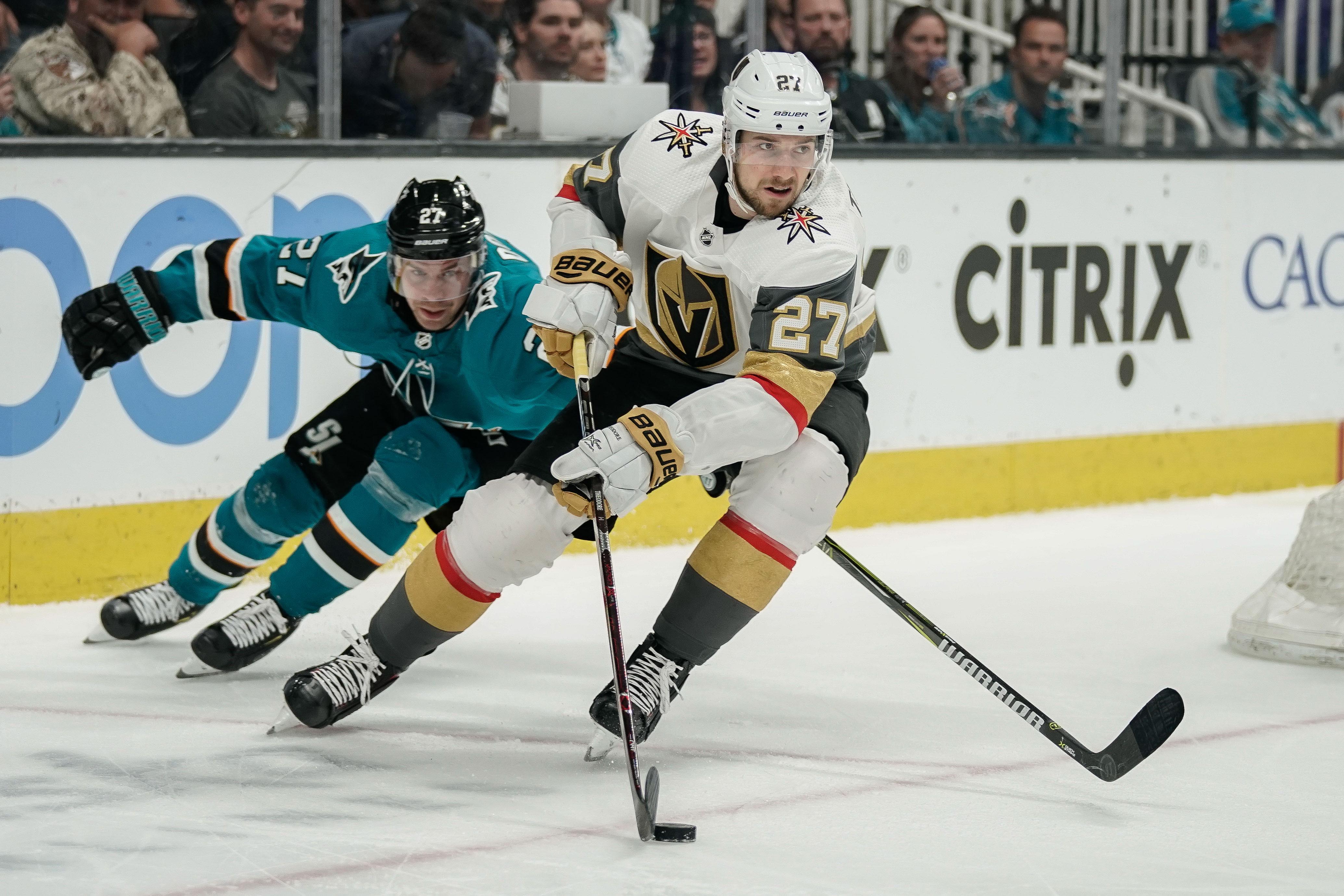 Mar 30, 2019; San Jose, CA, USA; San Jose Sharks right wing Joonas Donskoi (27) and Vegas Golden Knights defenseman Shea Theodore (27) fight for control of the puck during the third period at SAP Center at San Jose