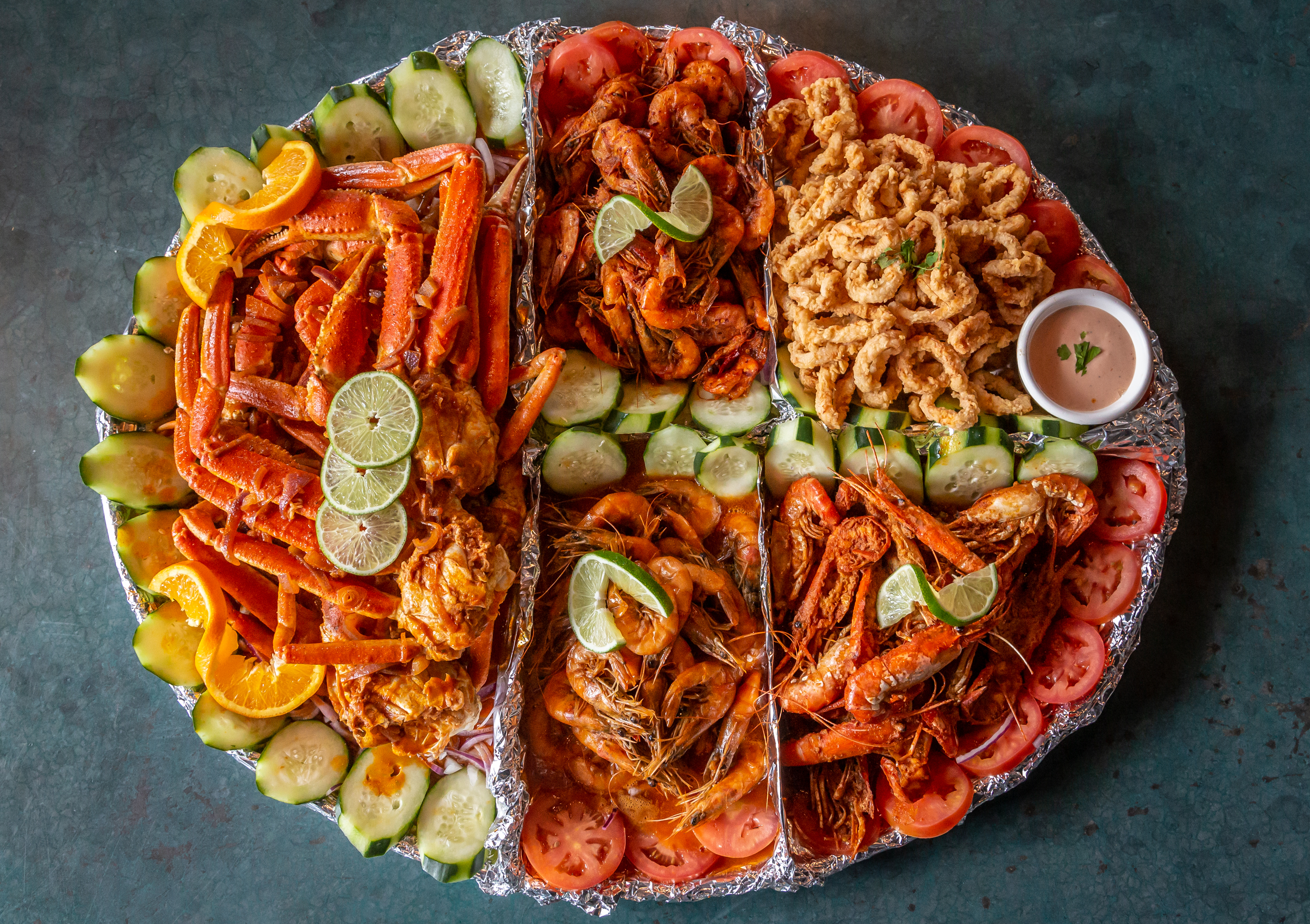 The charola platter with crab legs, langoustines, shrimp, clams, and fried fish at Mariscos La Riviera Nayarit