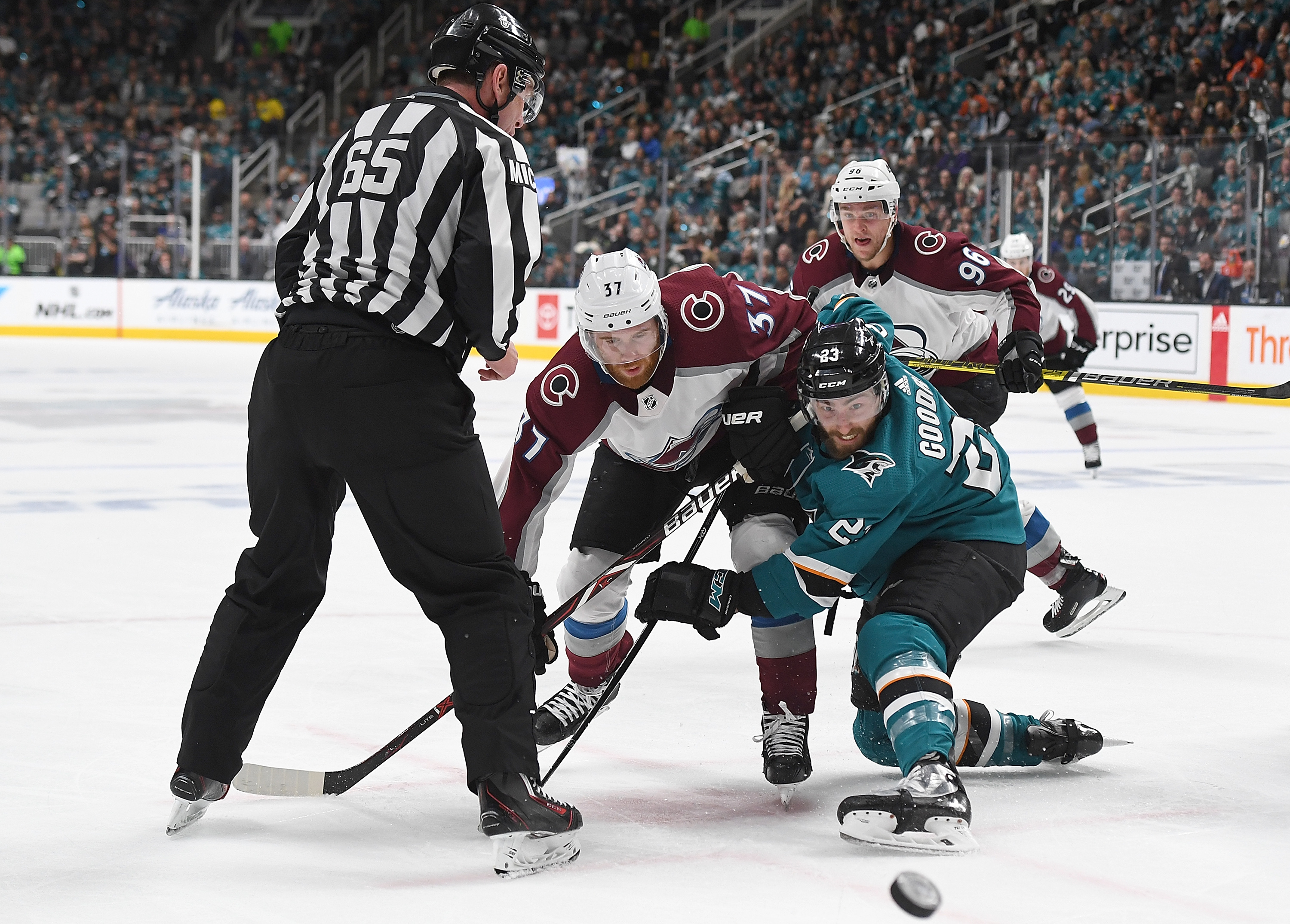 Barclay Goodrow of the San Jose Sharks and J.T. Compher of the Colorado Avalanche battles for a faceoff during the third period in Game 1 of the Western Conference Second Round during the 2019 NHL Stanley Cup Playoffs at SAP Center on April 26, 2019 in Sa