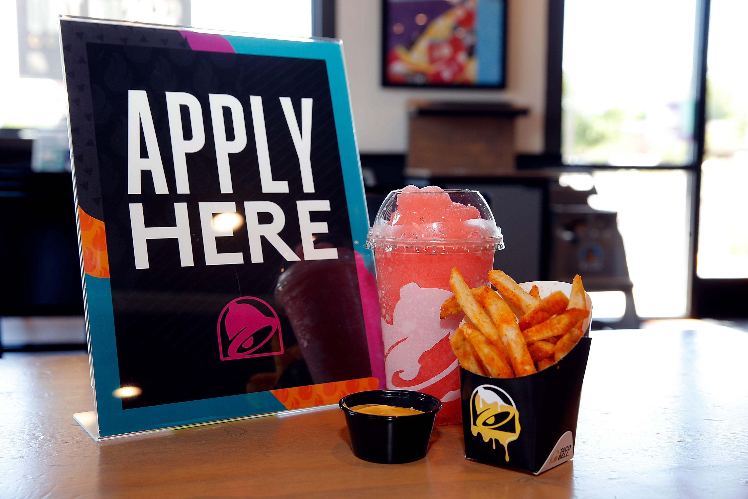 Apply Here sign with Taco Bell food