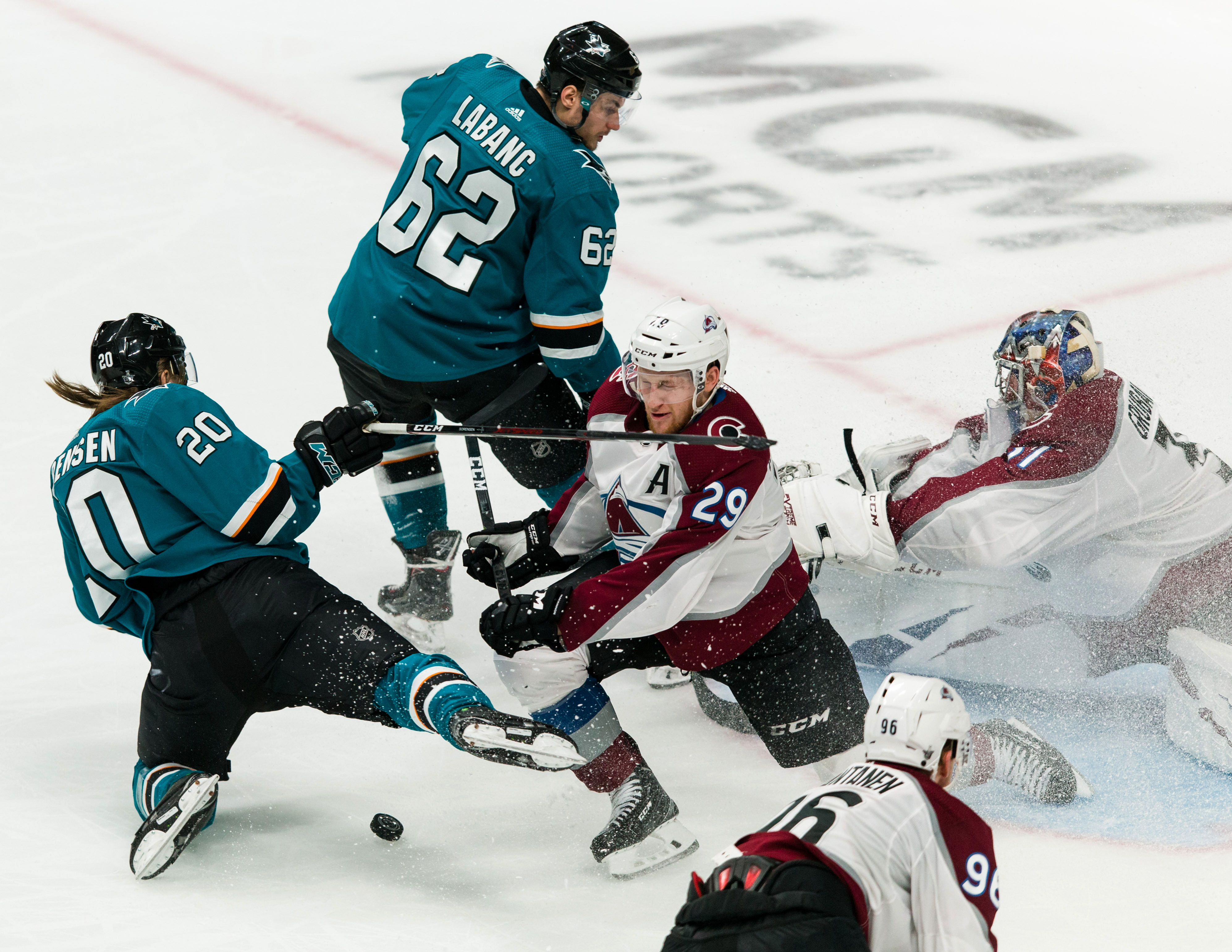 Colorado Avalanche goaltender Philipp Grubauer and center Nathan MacKinnon defend against a shot by San Jose Sharks right wing Kevin Labanc as left wing Marcus Sorensen stumbles in the third period of Game 2 of the second round of the 2019 Stanley Cup Pla