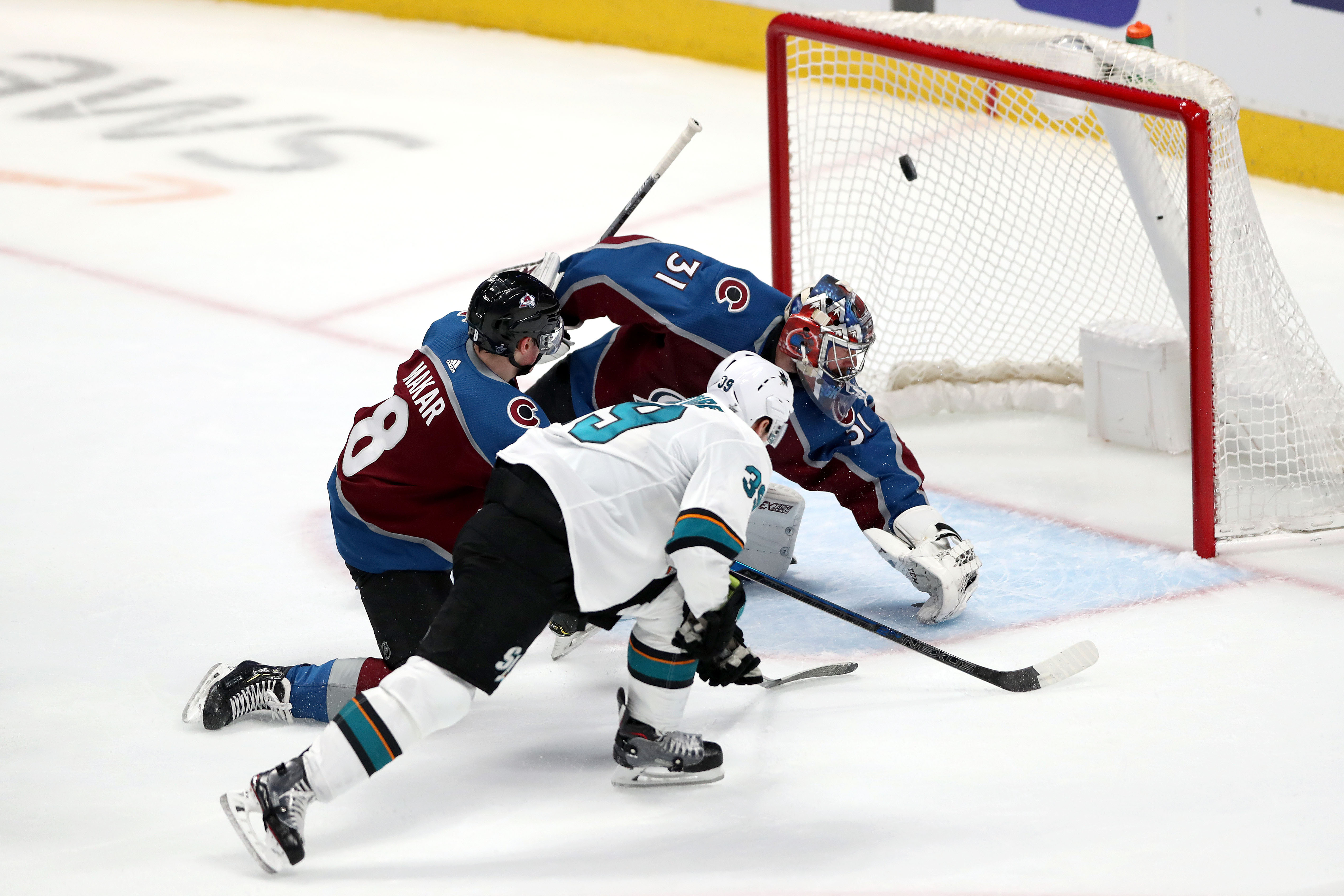 Logan Couture of the San Jose Sharks scores a goal past Cale Makar and goalie Philipp Grubauer of the Colorado Avalanche in Game 3 of the Western Conference Second Round during the 2019 NHL Stanley Cup Playoffs at the Pepsi Center on April 30, 2019 in Den
