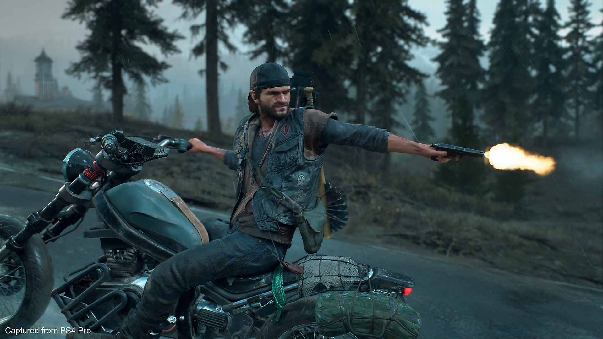 A man rides a motorcycle while turning around to shoot at something behind him