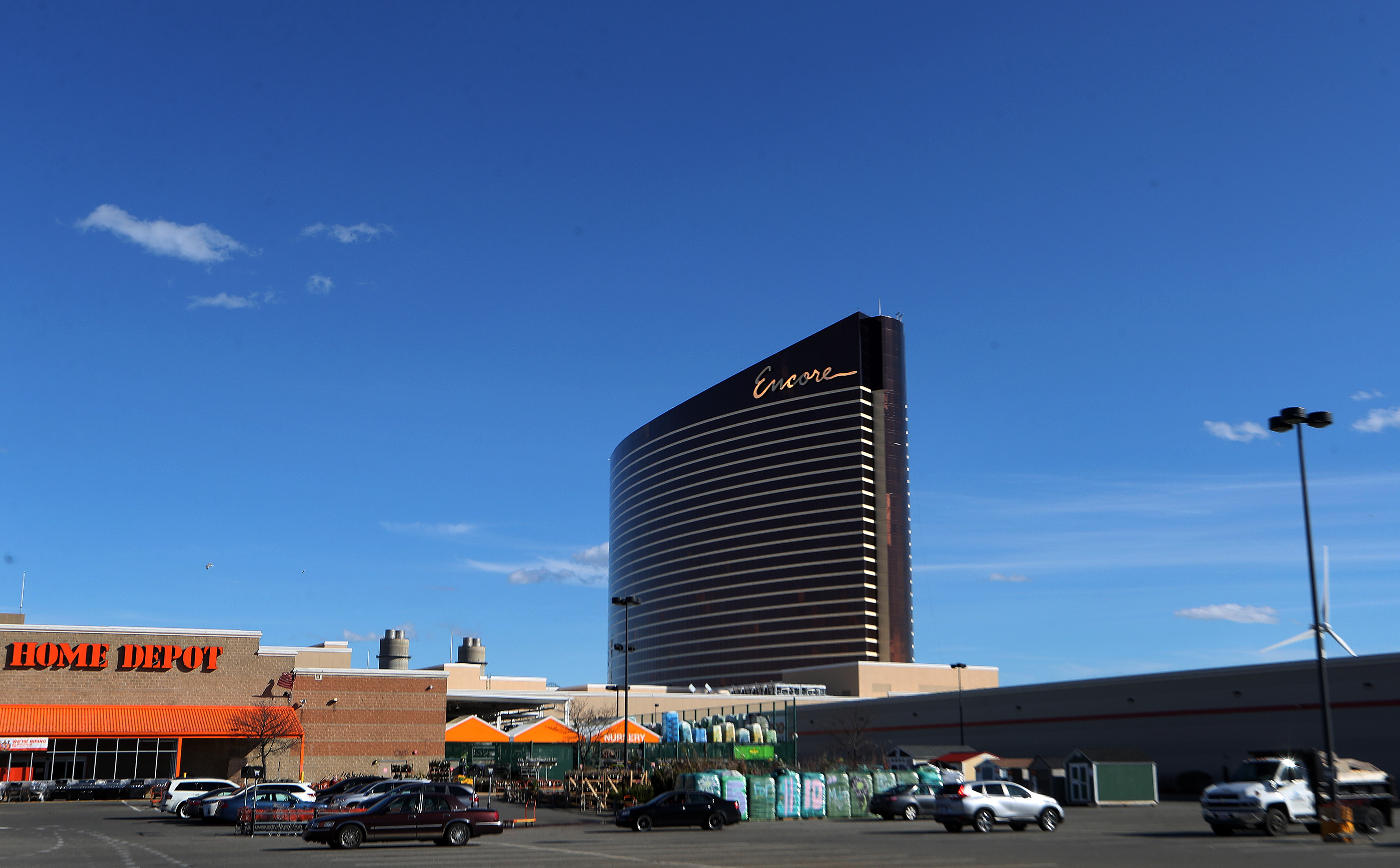 A large, rectangular, and curved building looming over a parking lot. 