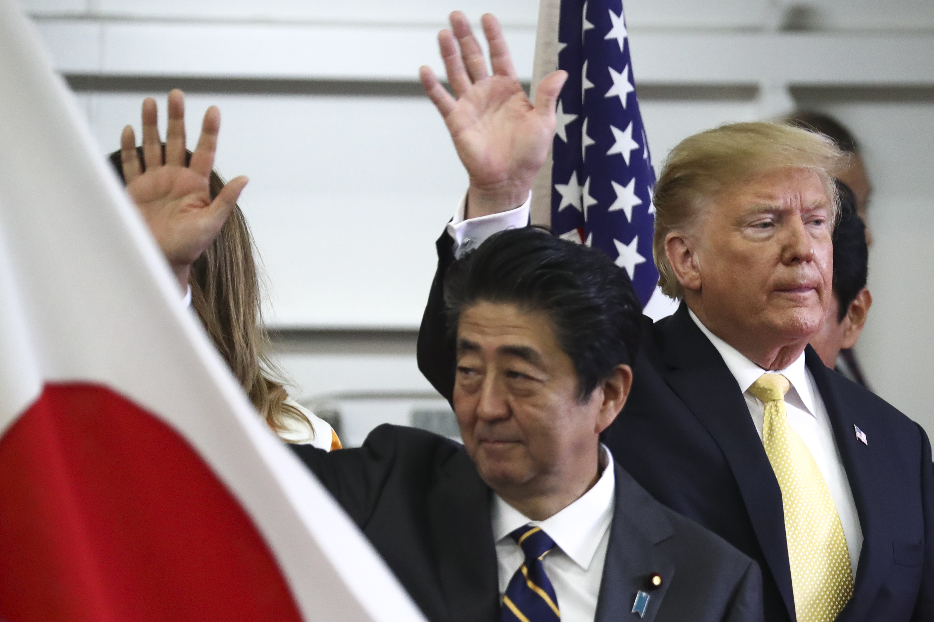 President Donald Trump and Japan’s Prime Minister Shinzo Abe wave after delivering a speech to Japanese and US troops on May 28, 2019 in Yokosuka, Japan.