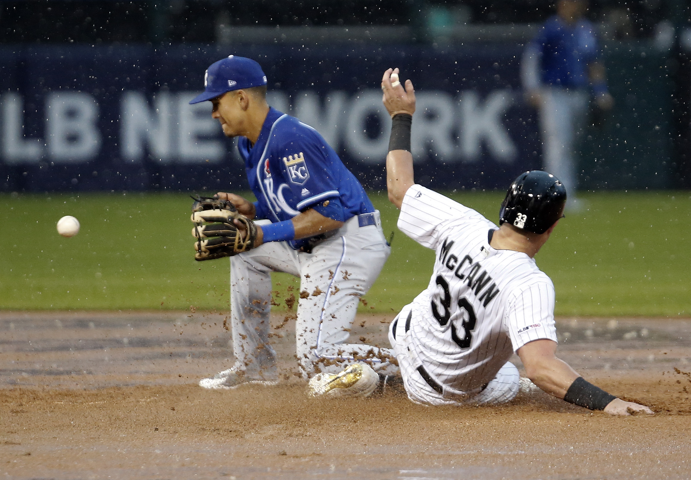 James McCann #33 of the Chicago White Sox goes to second while Nicky Lopez #1 of the Kansas City Royals catches the throw from third base during the fifth inning at Guaranteed Rate Field on May 27, 2019 in Chicago, Illinois.