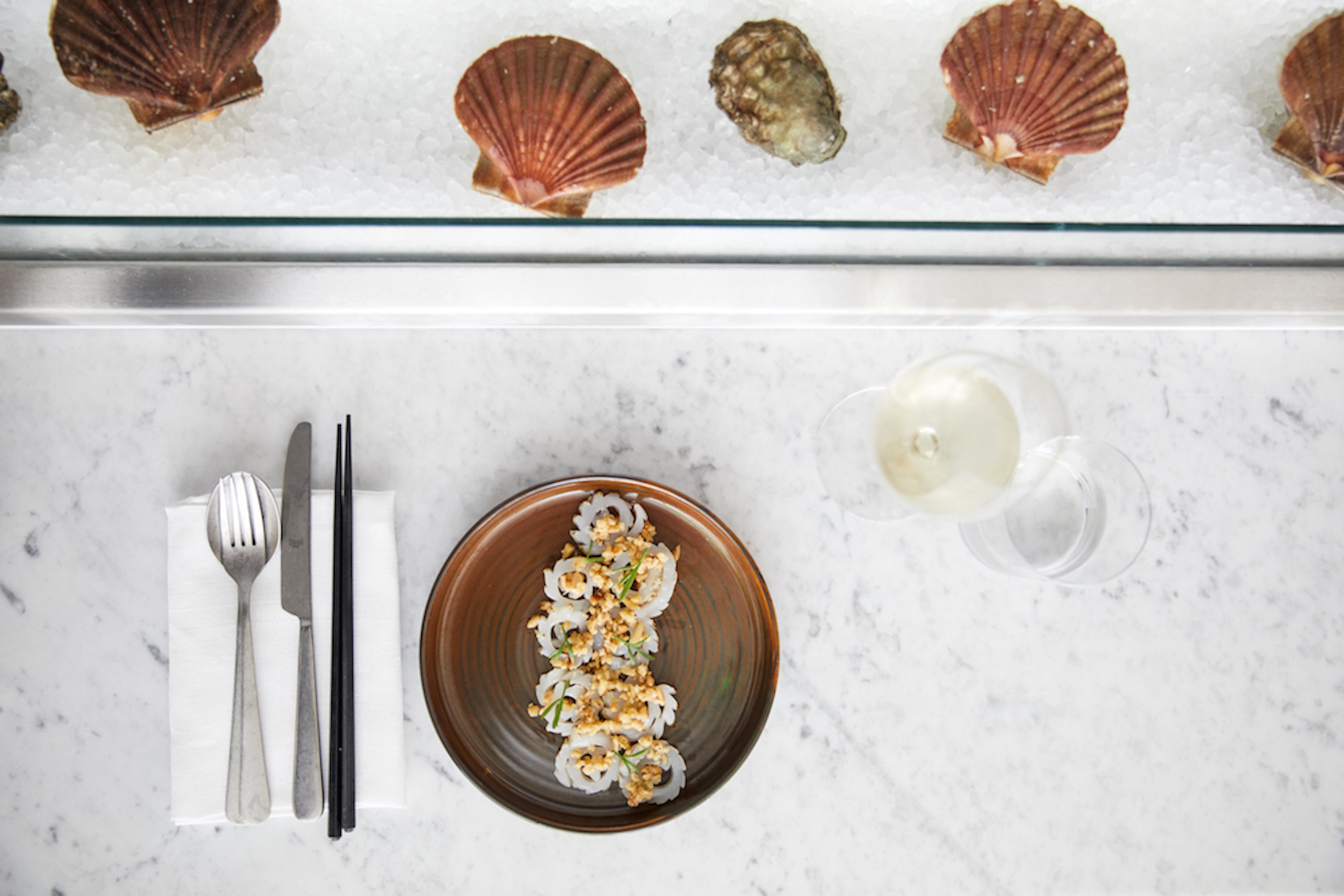 A fish dish with scallop shells and oysters on ice at London seafood restaurant The Sea The Sea