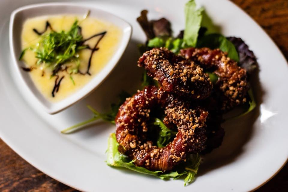 Pecan-crusted, bacon-wrapped and sorghum-glazed onion rings with brie cheese dipping sauce