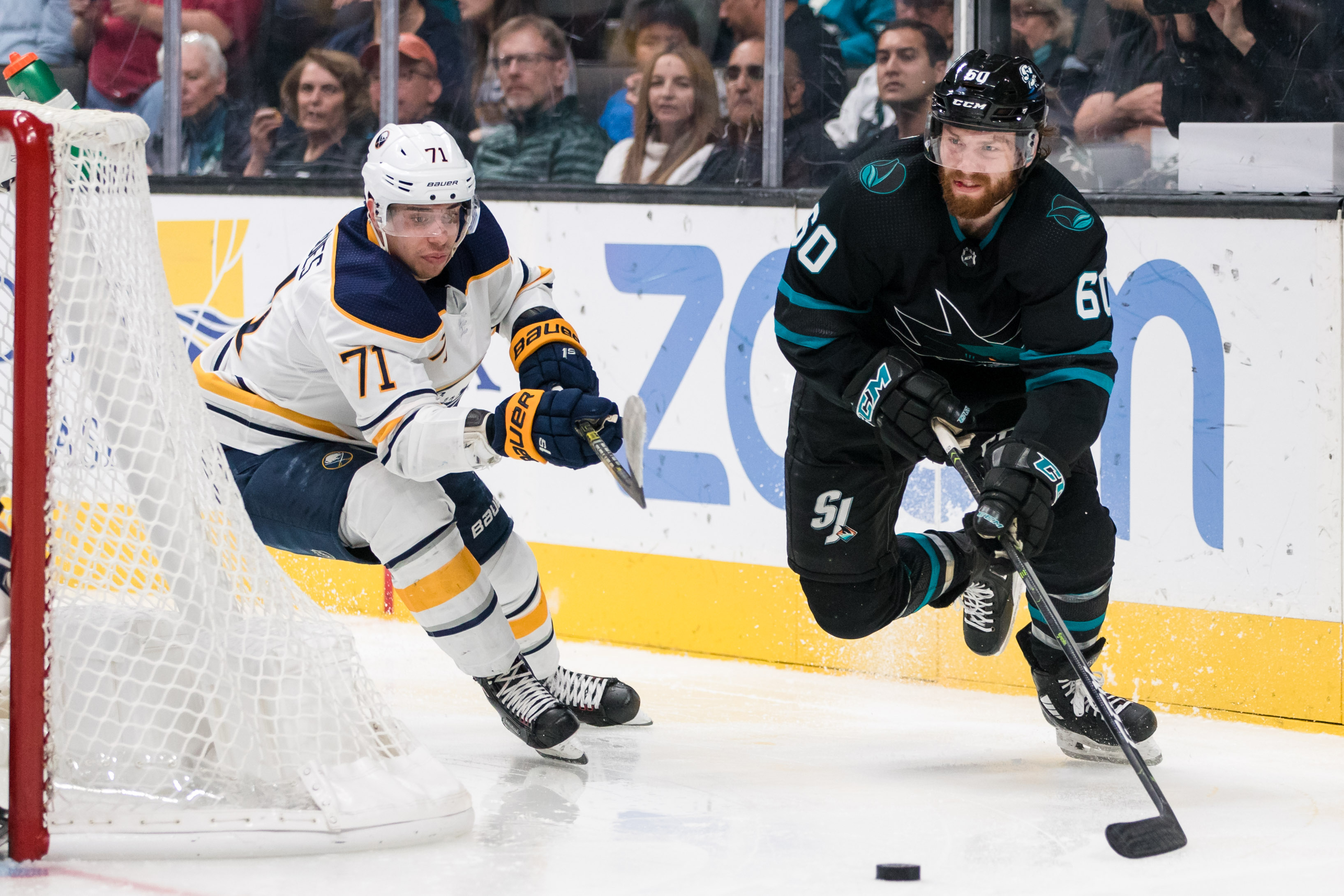 Oct 18, 2018; San Jose, CA, USA; San Jose Sharks center Rourke Chartier (60) passes as Buffalo Sabres left wing Evan Rodrigues (71) defends in the second period at SAP Center at San Jose.