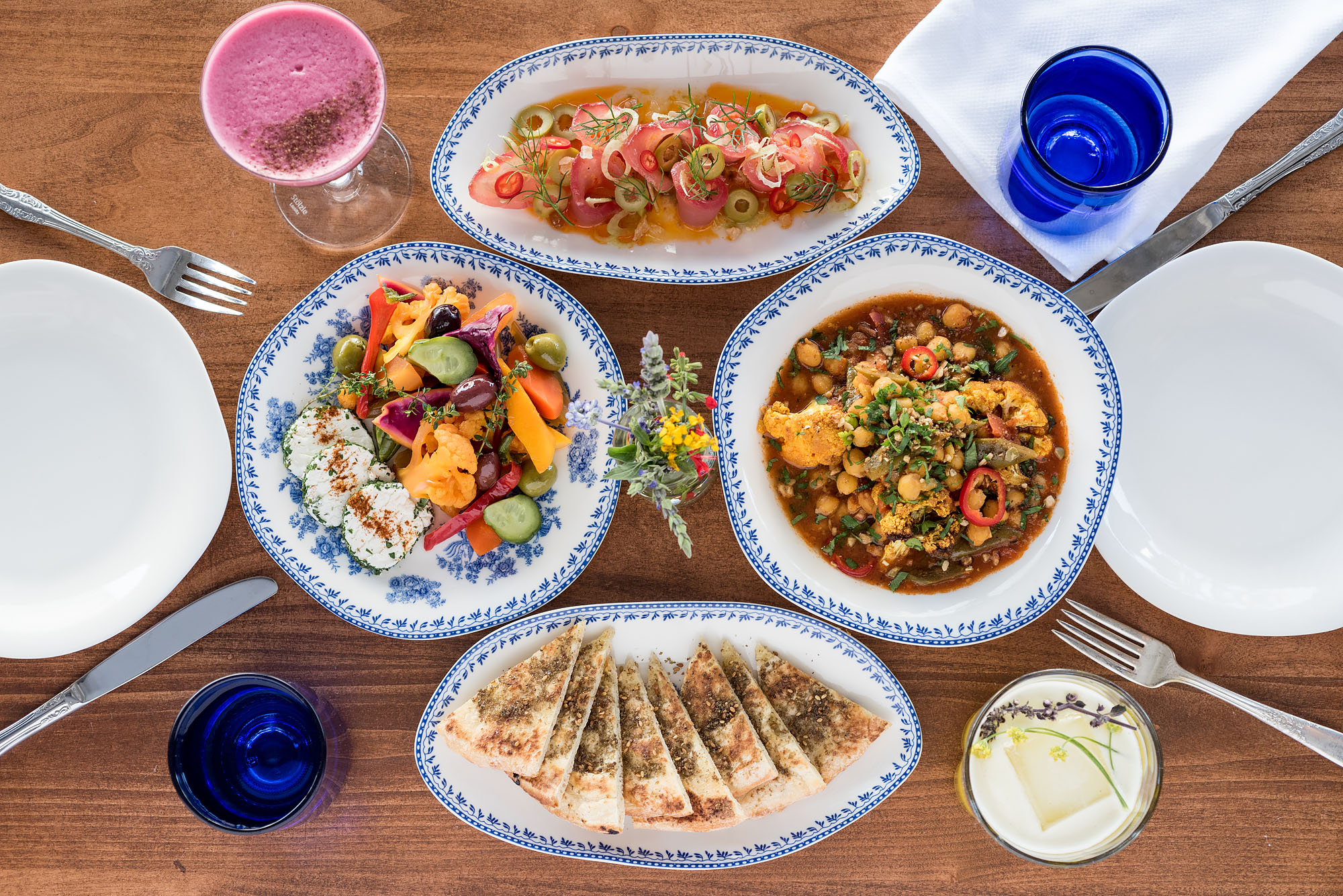 Array of dishes on white and blue plates at Jaffa restaurant