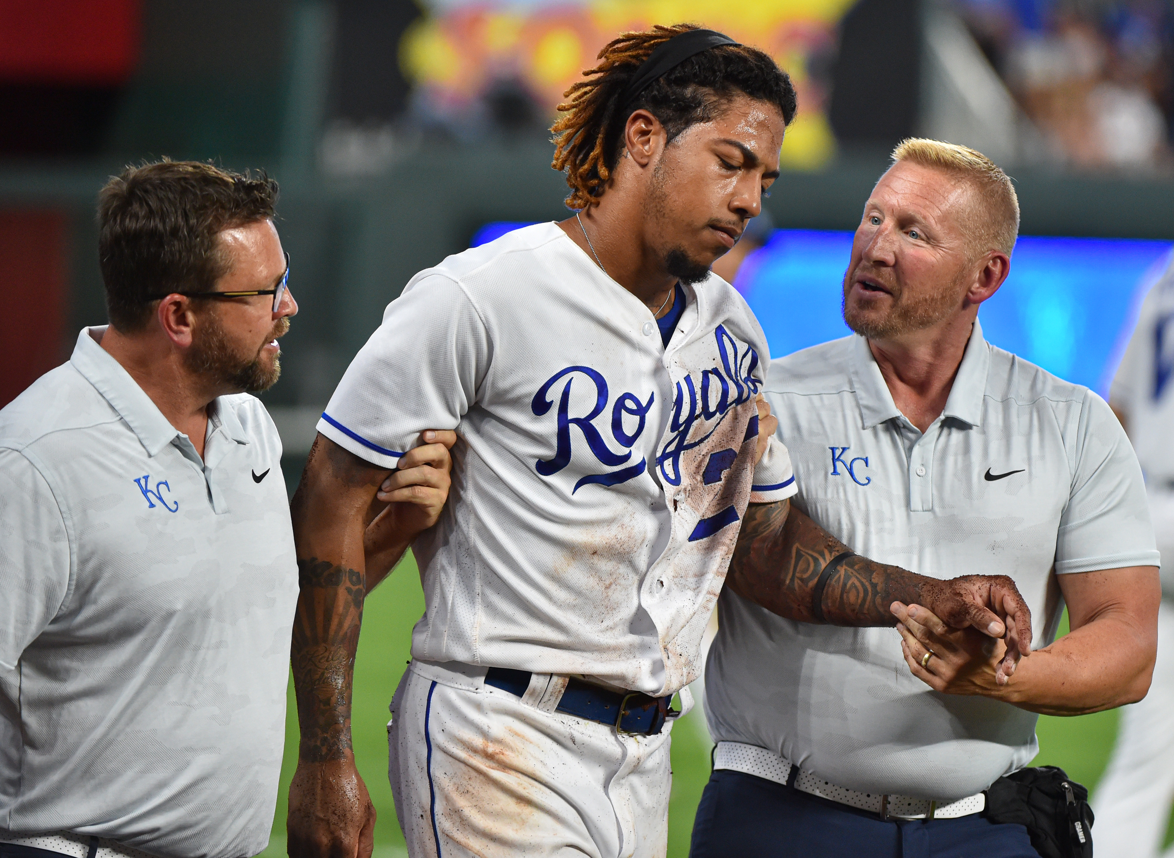 Adalberto Mondesi #27 of the Kansas City Royals is helped off the field by a team trainers after he was injured while trying to catch a foul ball hit by Yolmer Sanchez #5 of the Chicago White Sox in the fifth inning at Kauffman Stadium on July 16, 2019 in