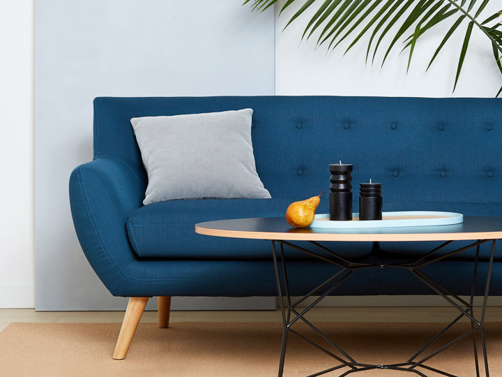 blue sofa with accent pillow and coffee table. 