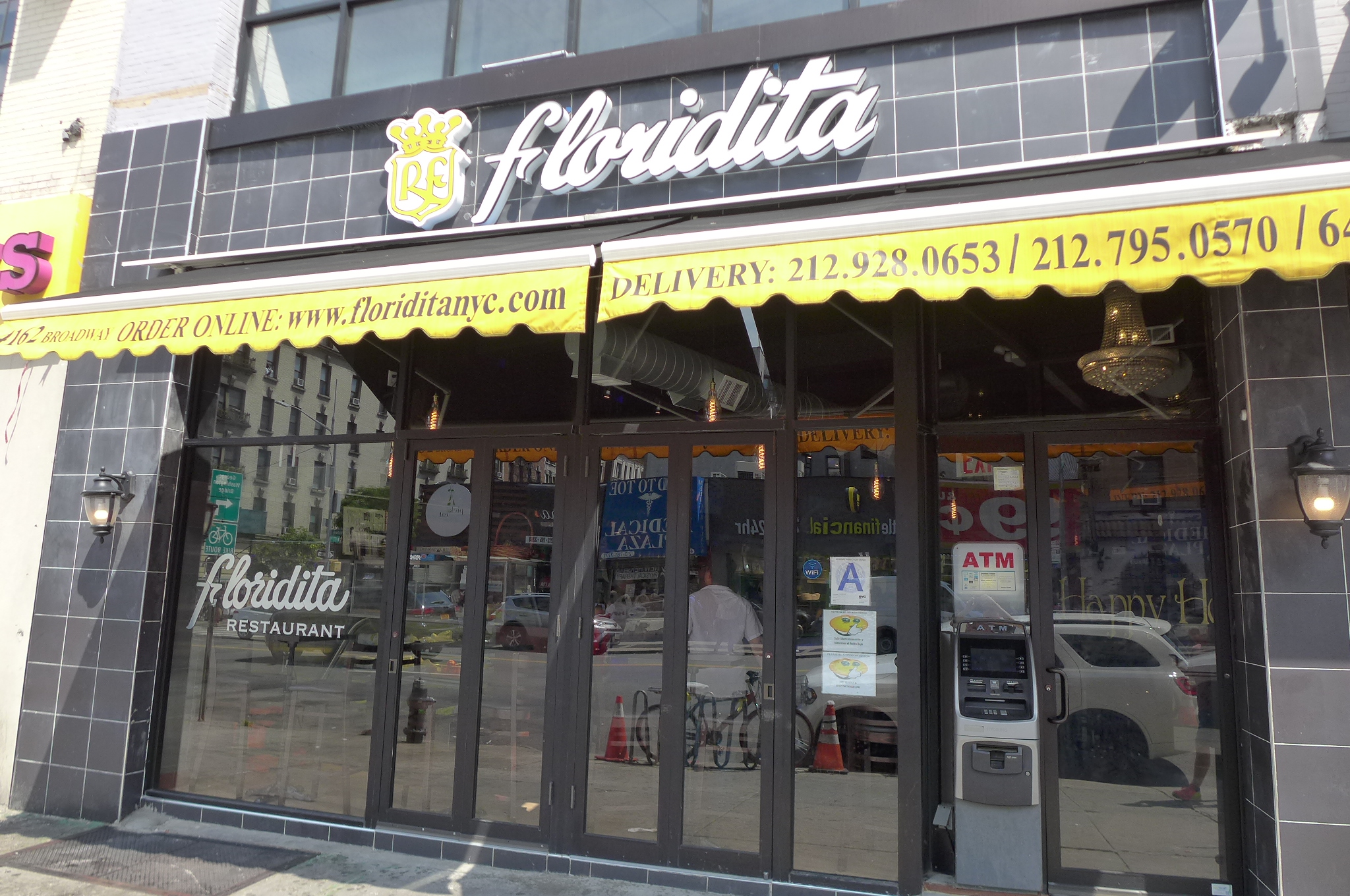 A black facade with a coat of arms and Floridita in cursive.