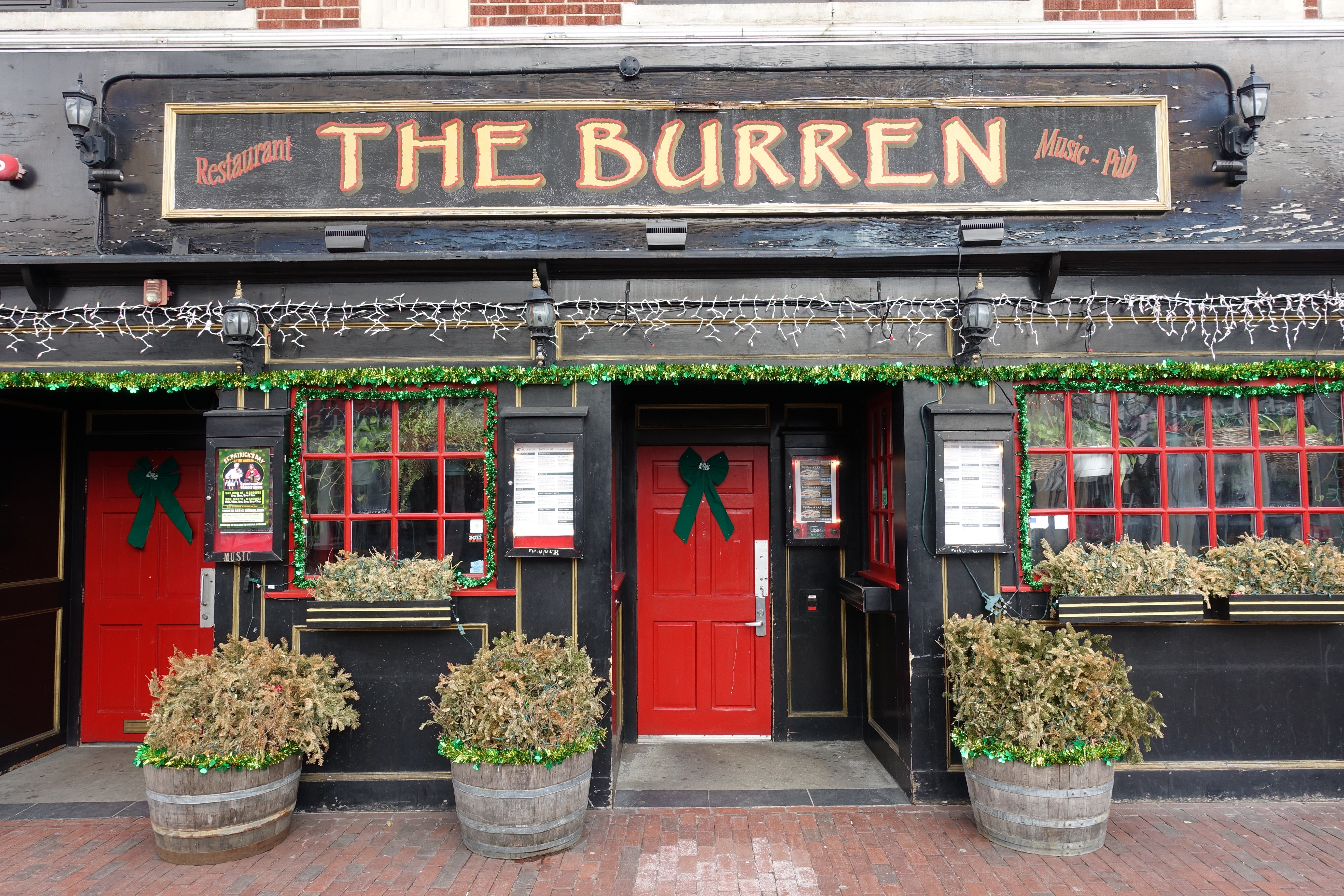 The exterior of the Burren in Somerville’s Davis Square, painted black with bright red doors and window frames