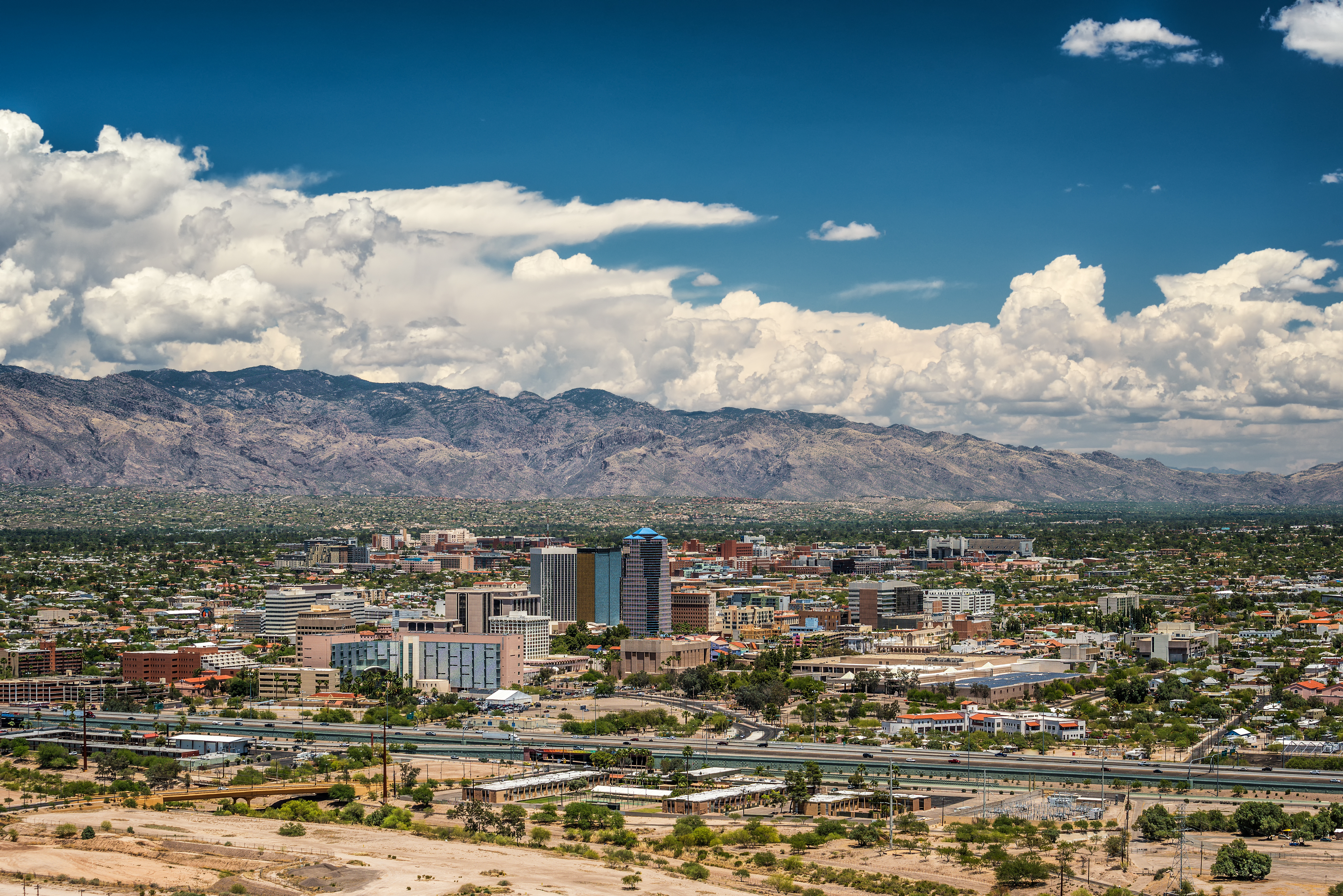 aerial view of Tucson skyline, with mountains in the background.