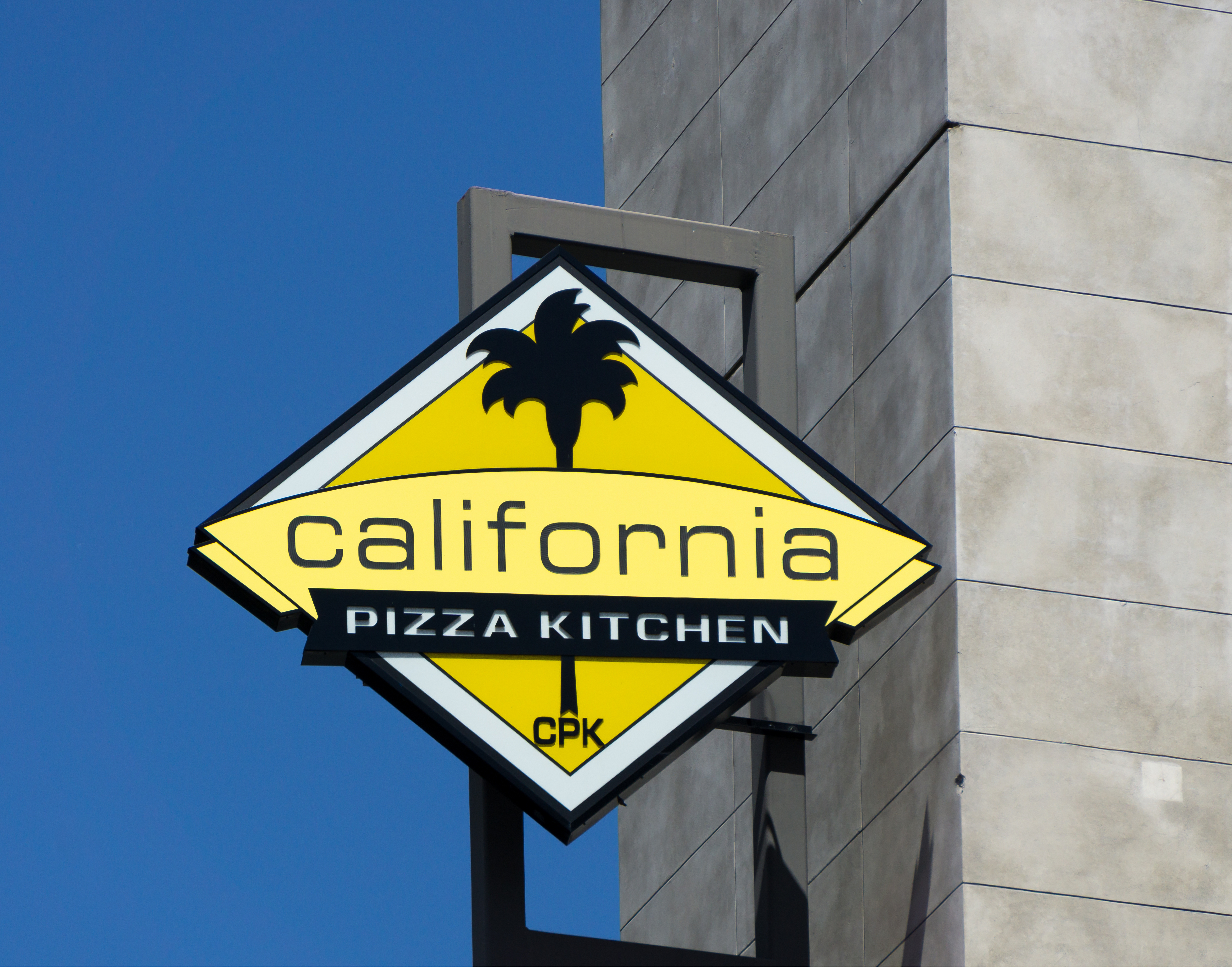 A sign for California Pizza Kitchen, the longtime fast casual chain.