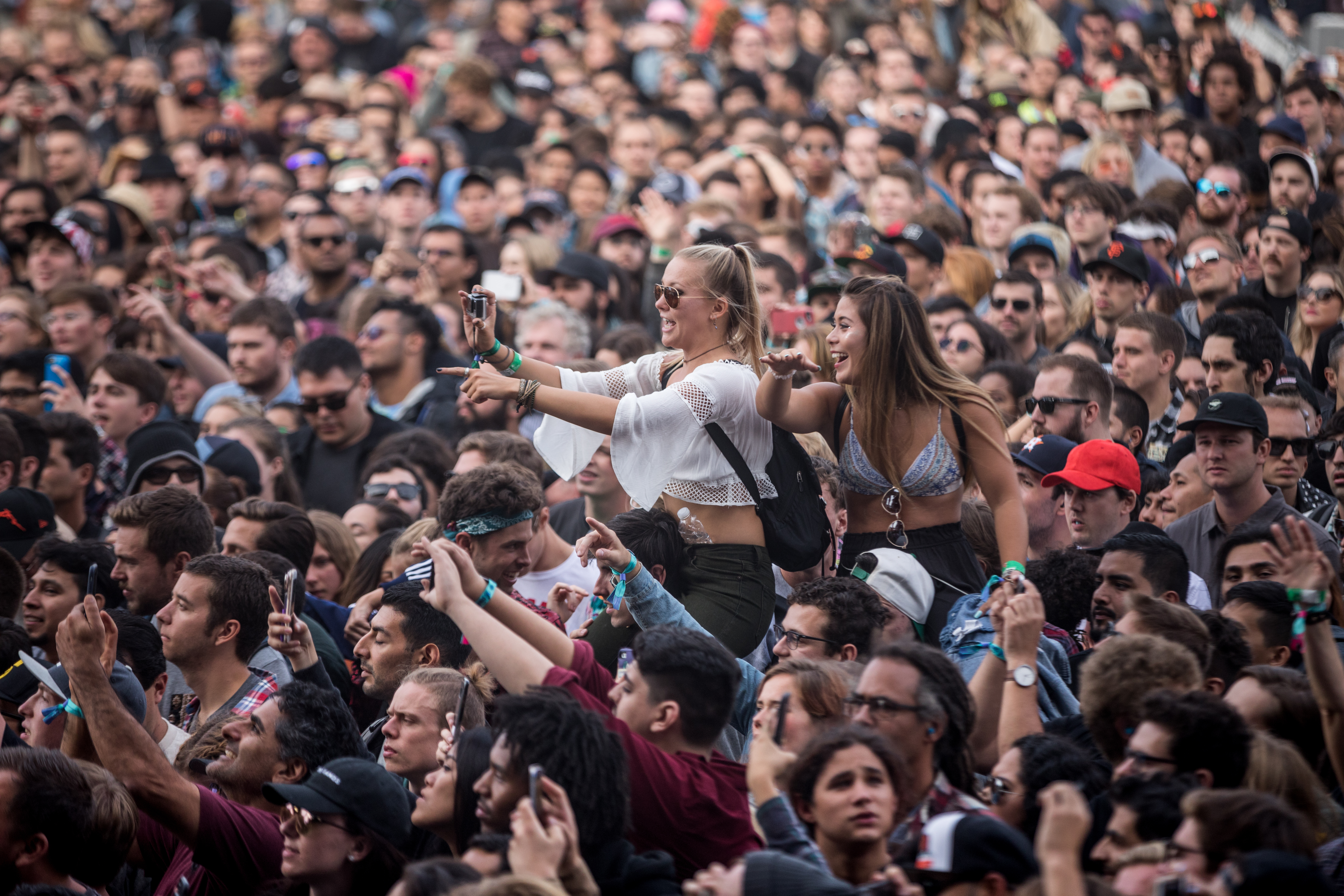 Shot of the crowd at Outside Lands 2017, filled with a lot of young people with their hands in the air.