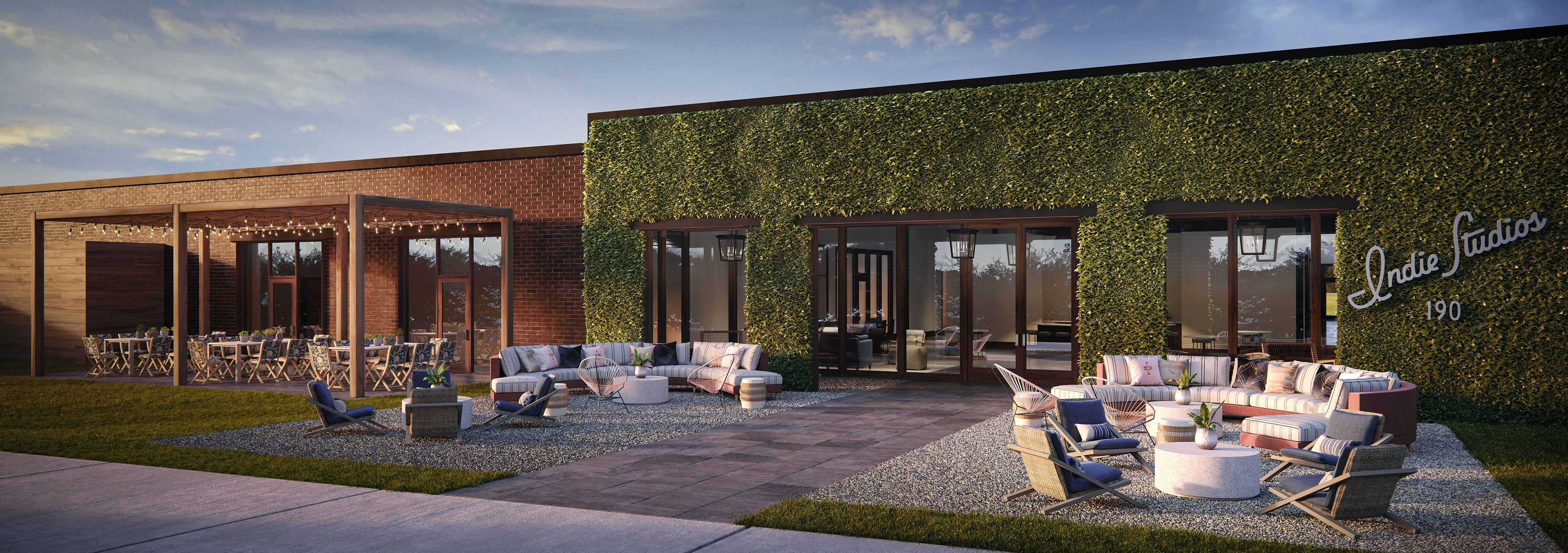 An outdoor patio space with green leafy wall and brick walls, in a rendering.