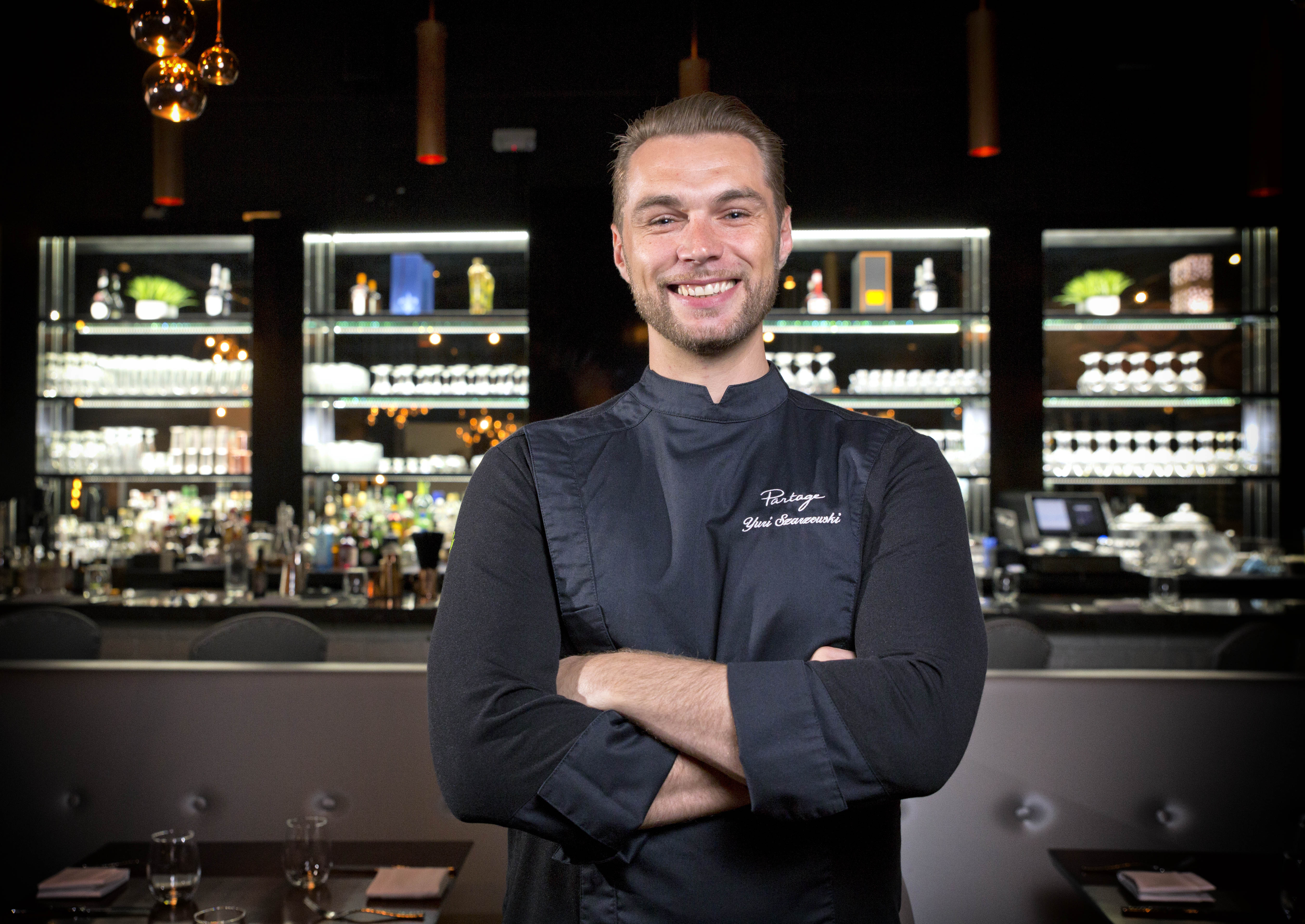 Chef wearing a black jacket with his arms crossed