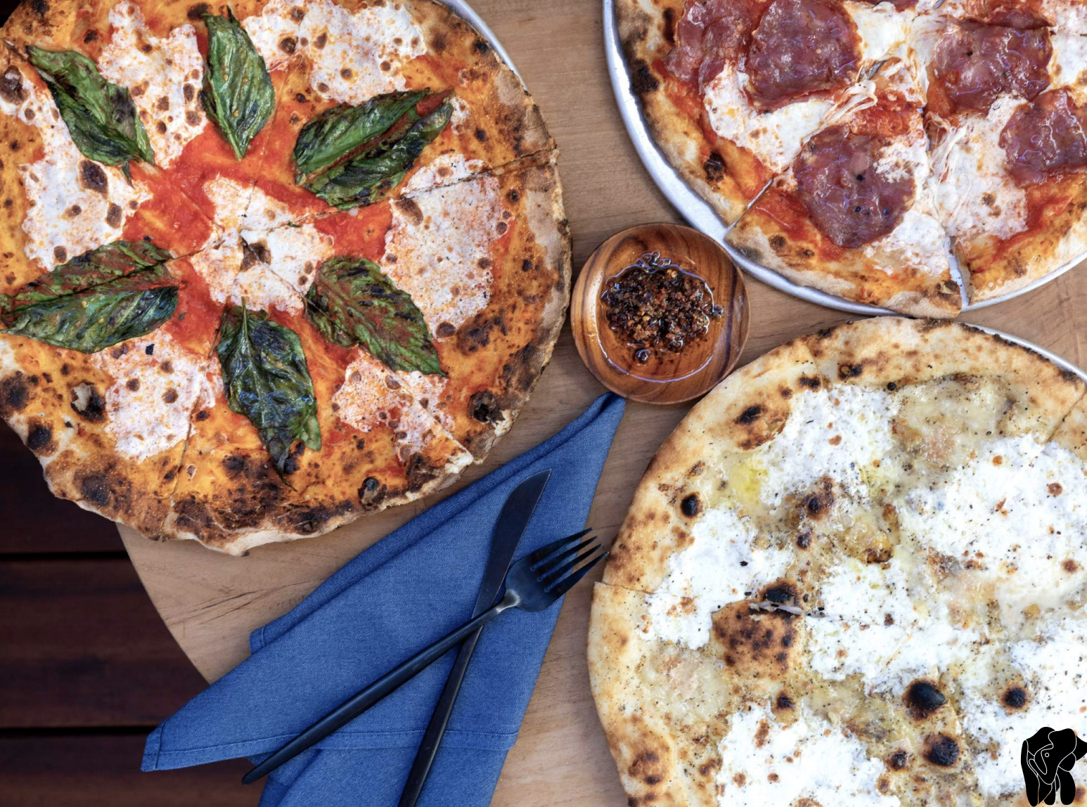 Pizzas, blistered and shot from overhead, shown at Elephante in Santa Monica.