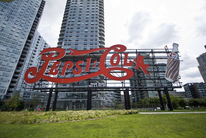 Red sign that reads Pepsi-Cola, which sits on the Long Island City waterfront.