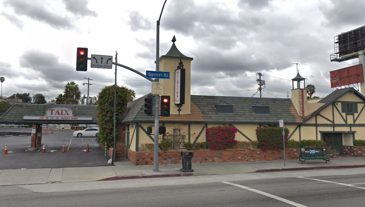 Street view of Taix Restaurant in Echo Park, a single-story building with green roof.
