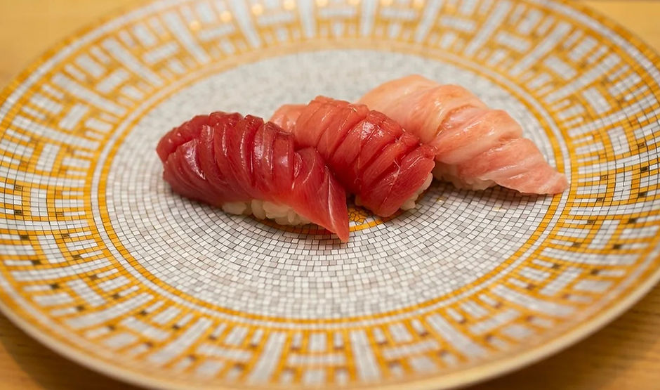 Three pieces of fish sushi.