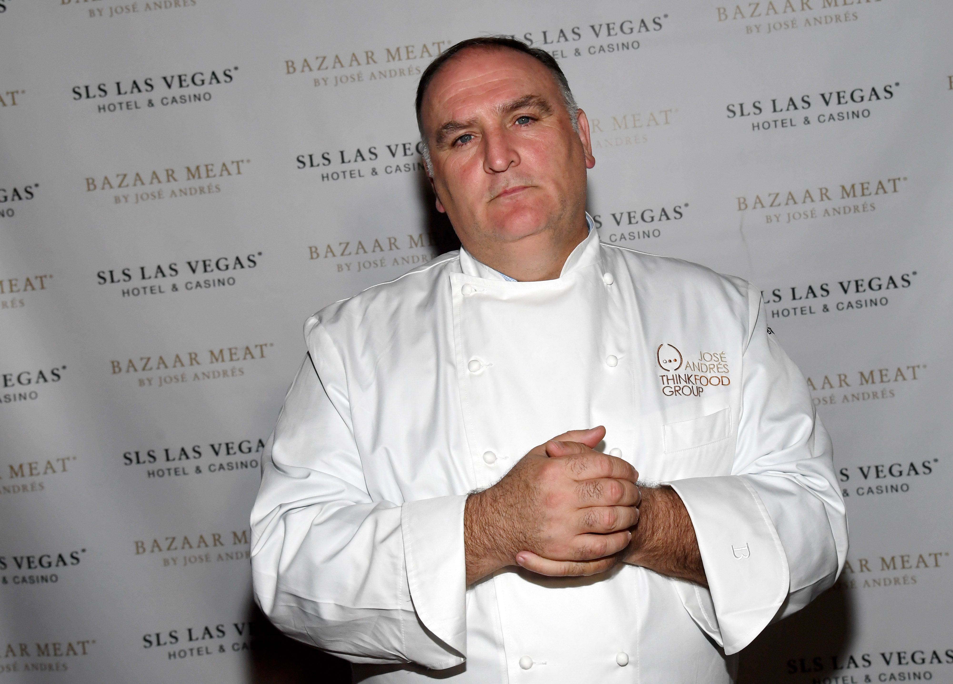 José Andrés stands in front of a step and repeat