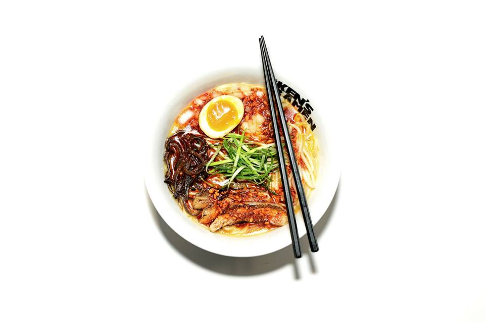 A bowl of ramen, shown from above with soft egg and chopsticks.