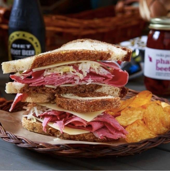 Two reuben sandwiches and bbq chips