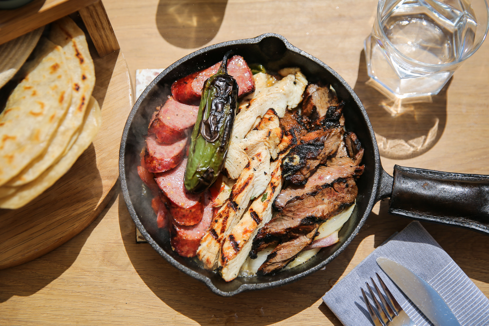 Republic Cantina’s “pick 3” fajita platter with brisket Czech sausage, chicken, and gochujang-marinated skirt steak