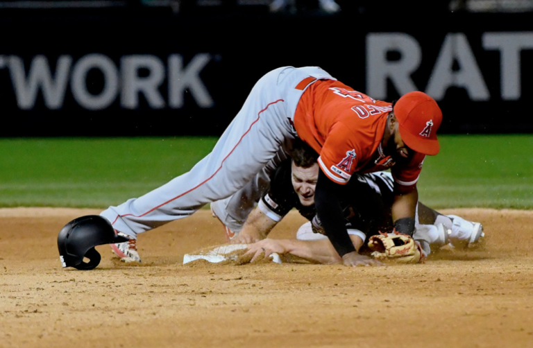 Angels second baseman Luis Rengifo lays on top of Adam Engel after forcing him out during the seventh inning Friday at Guaranteed Rate Field.