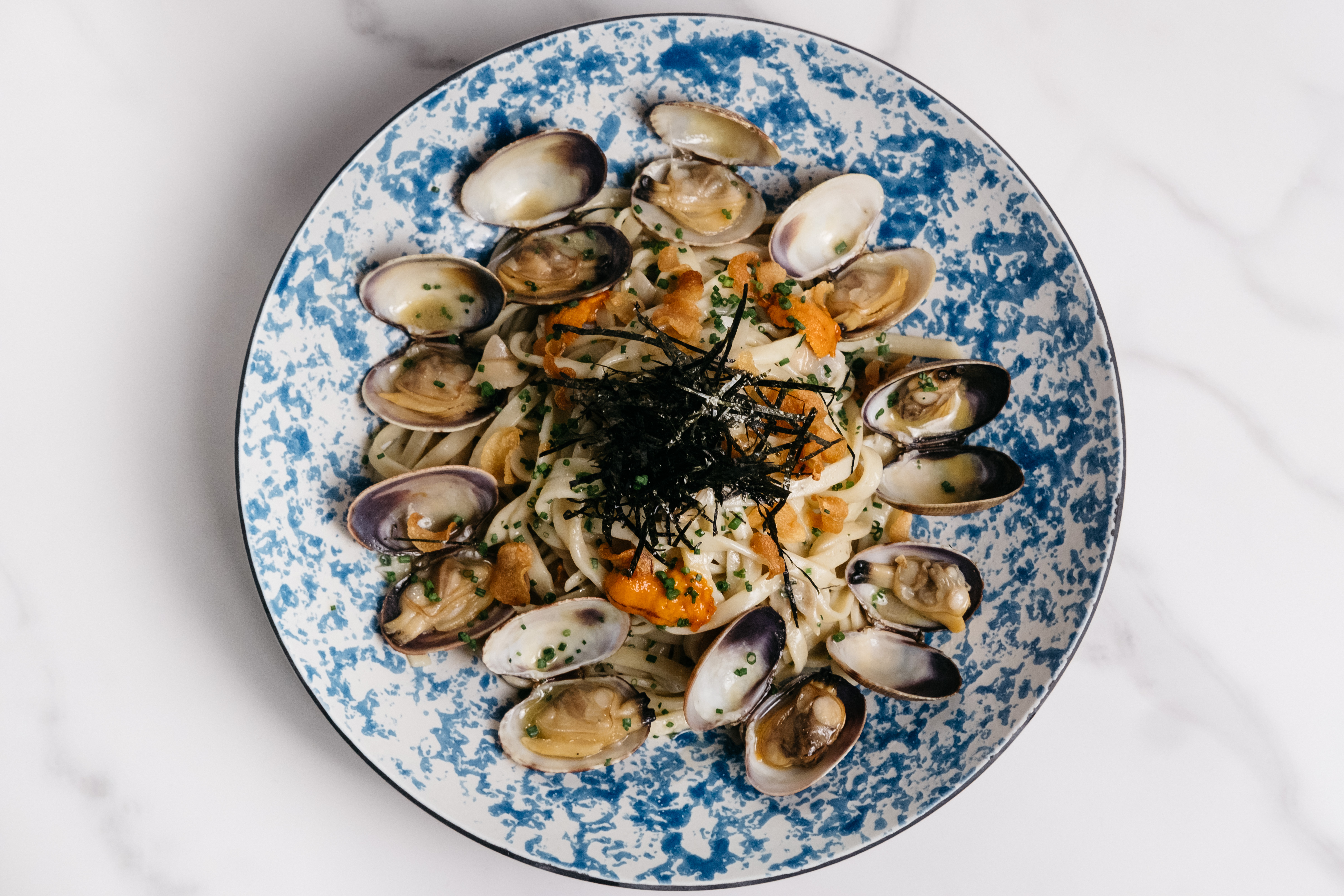 Navy Blue’s spaghetti vongole dish, with clams served over spaghetti with a garnish of seaweed.