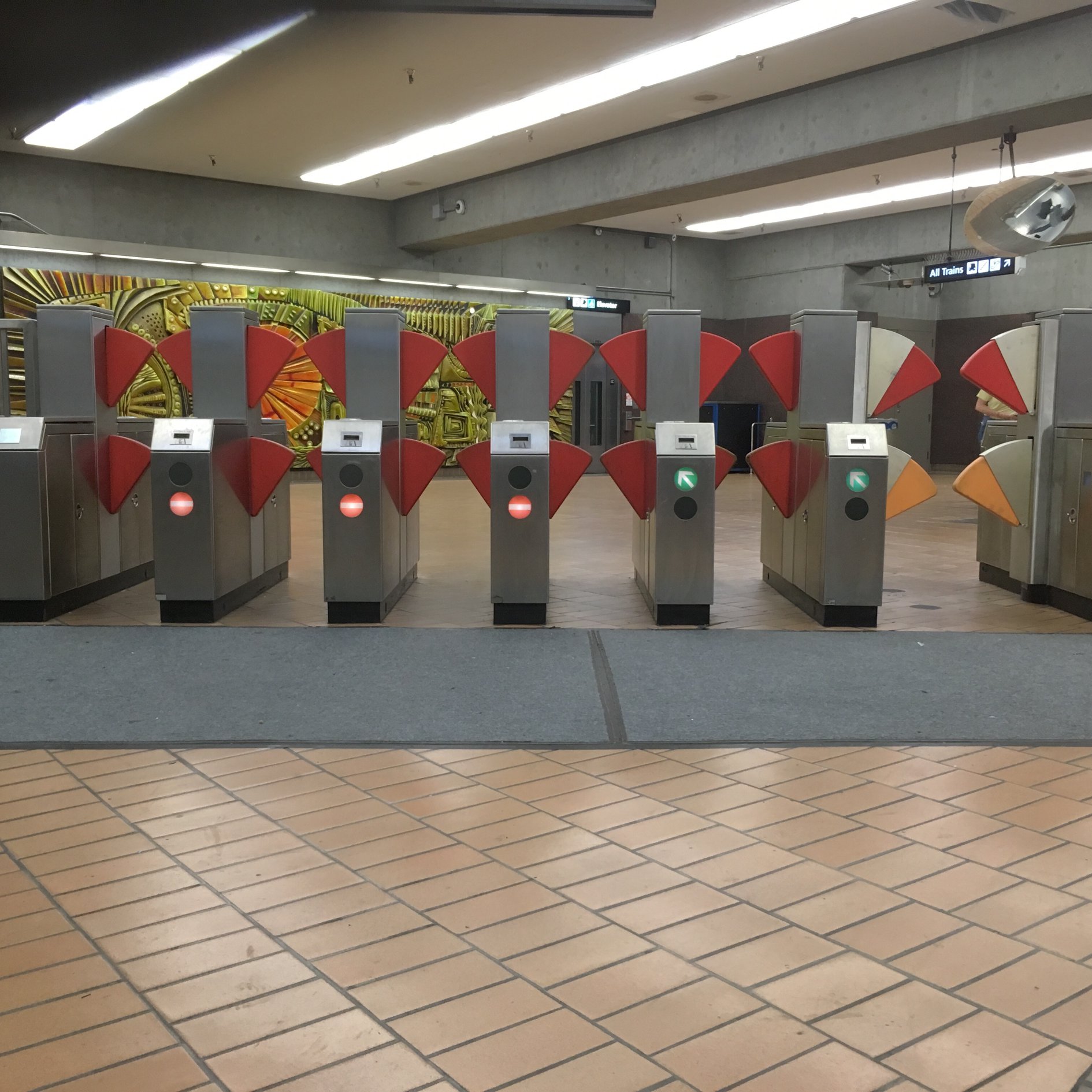 Transit fare gates with a lower and upper gates to prevent people from jumping over the gates.