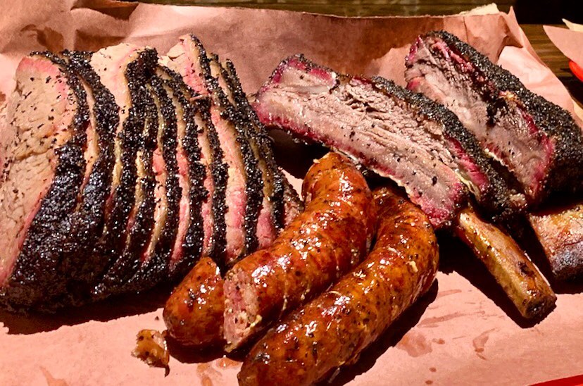 Smoked brisket, sausage, and ribs from Queue