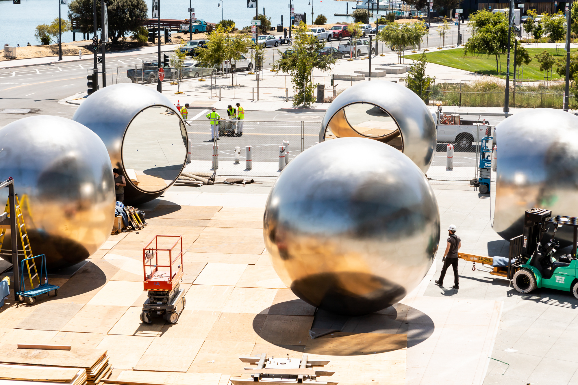 Five large steel globe-like structures in a circle, with mirrored inlays facing each other. It’s still under construction.