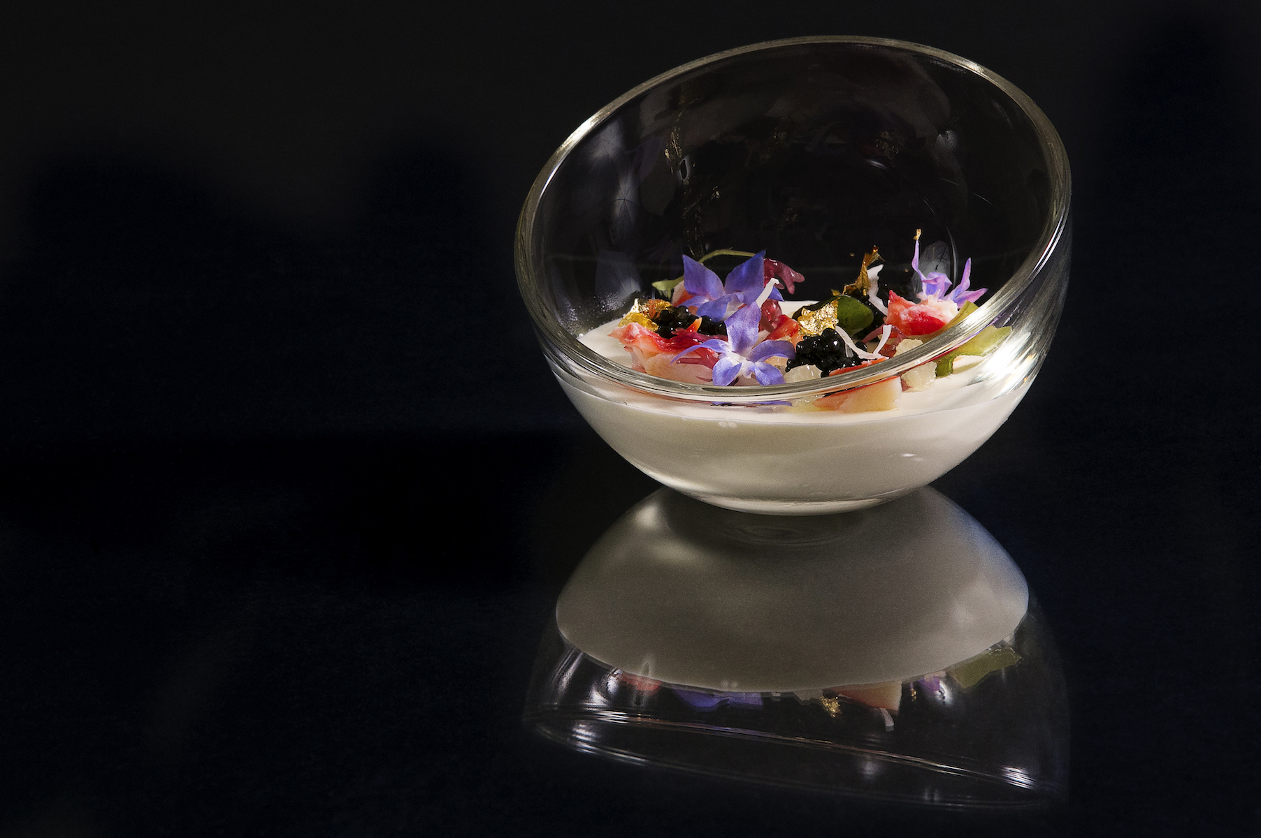 A glass bowl filled with colorful gastronomic delights. 
