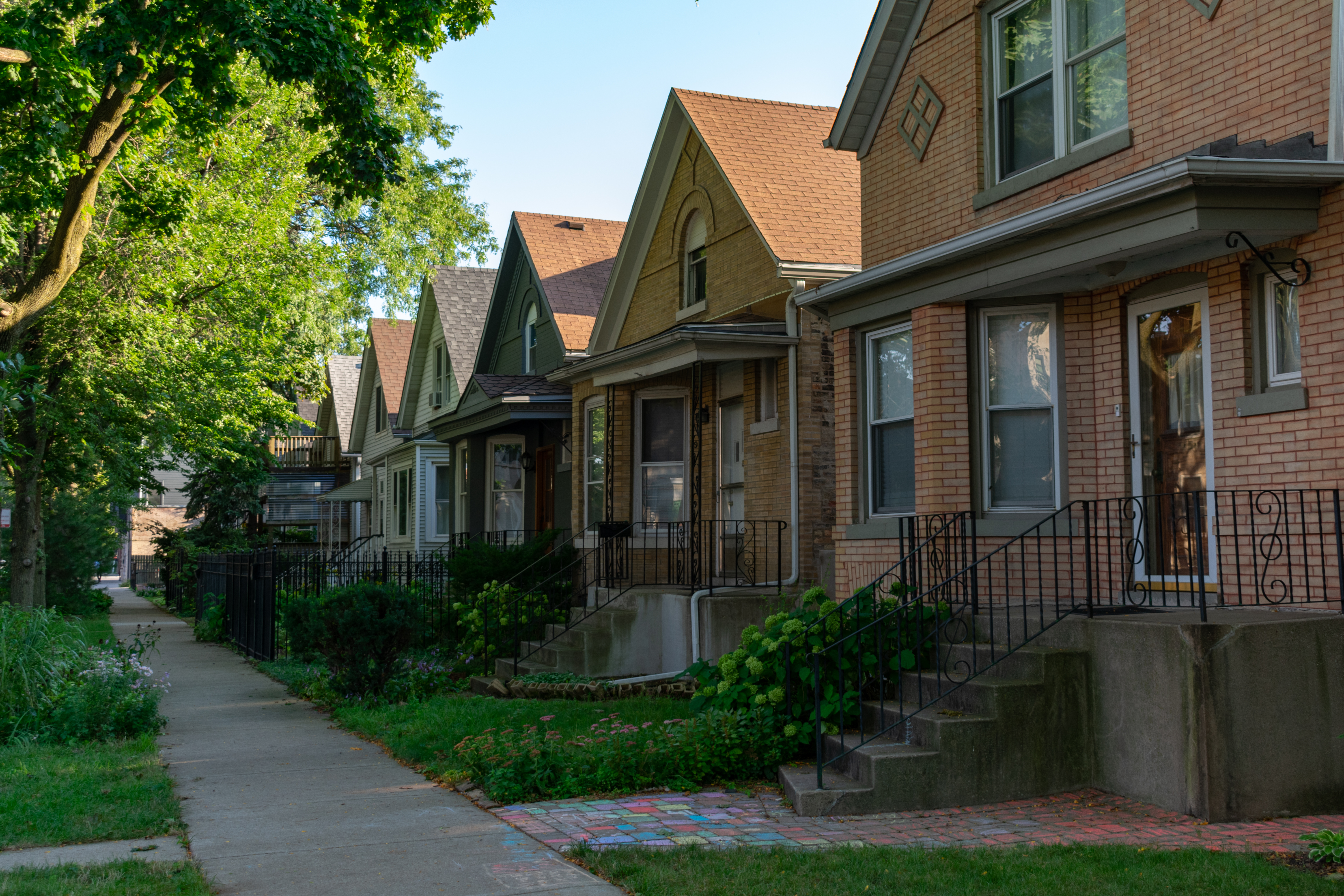 A row of brick homes in a neighborhood.