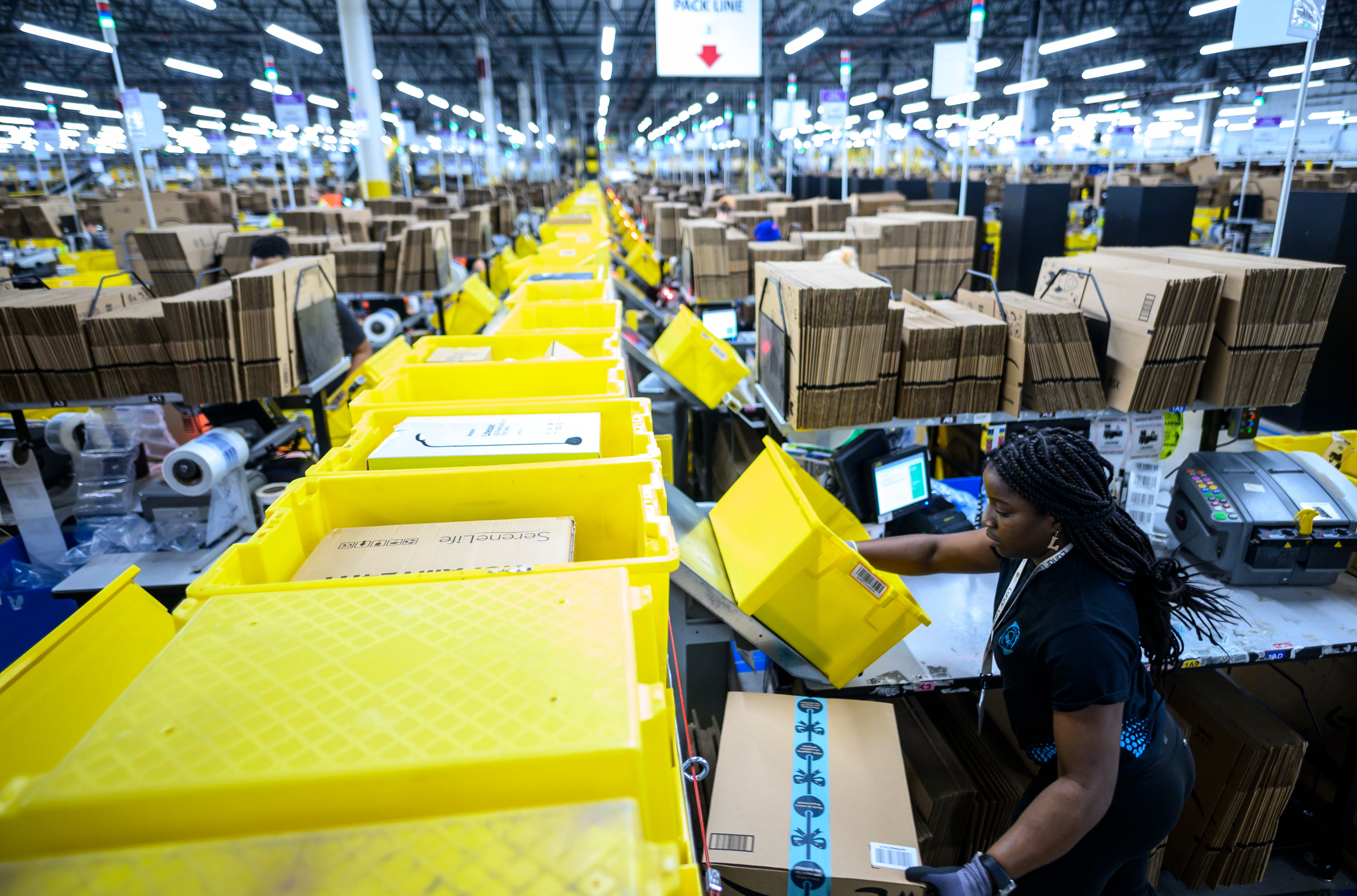 A woman works at Amazon’s huge packing station warehouse in Staten Island, New York City.