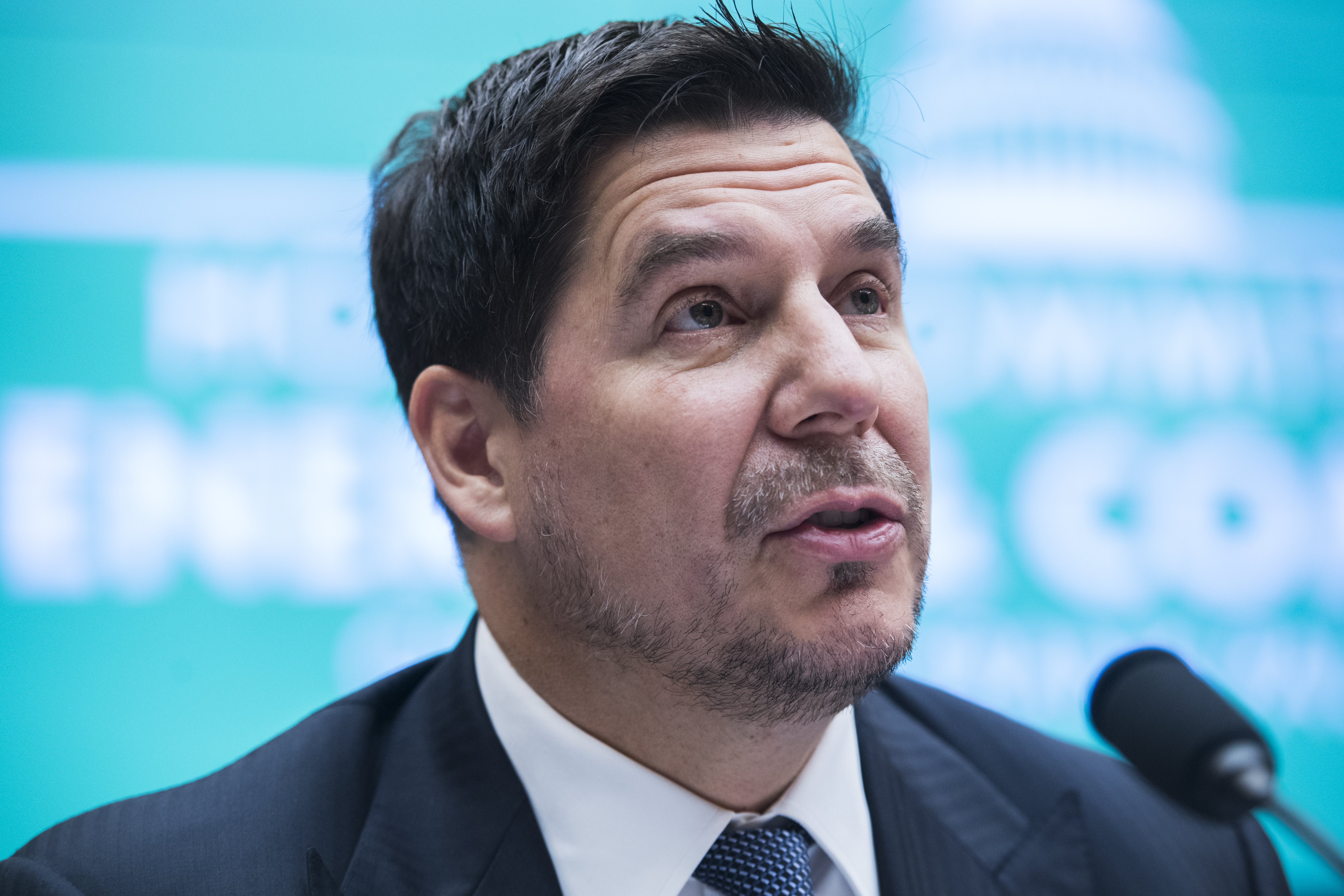 WeWork executive chair Marcelo Claure speaking into a microphone.