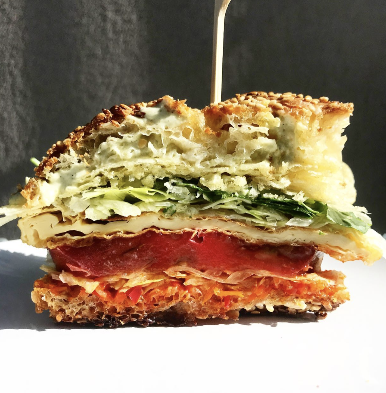 Sandwich made with tofu, tomatoes, and vegan mayo