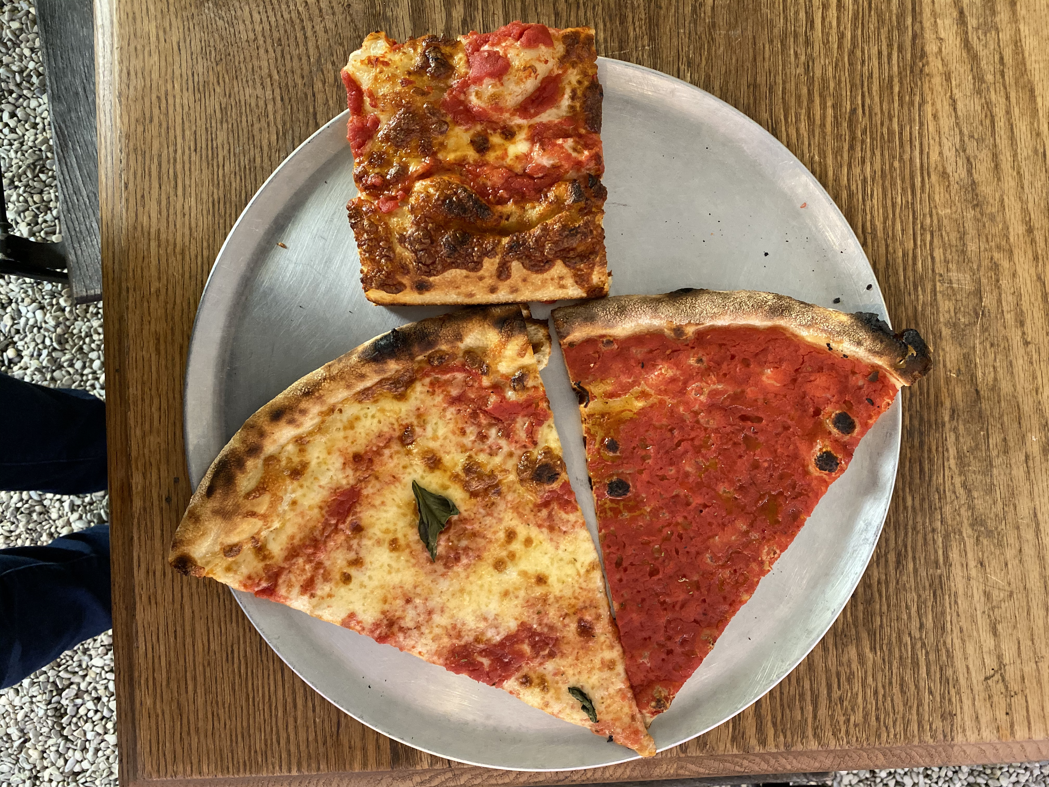 From top: The square Sicilian slice, followed by the triangular cheese and tomato slices at F&amp;F Pizzeria; the slices sit on a metal tray