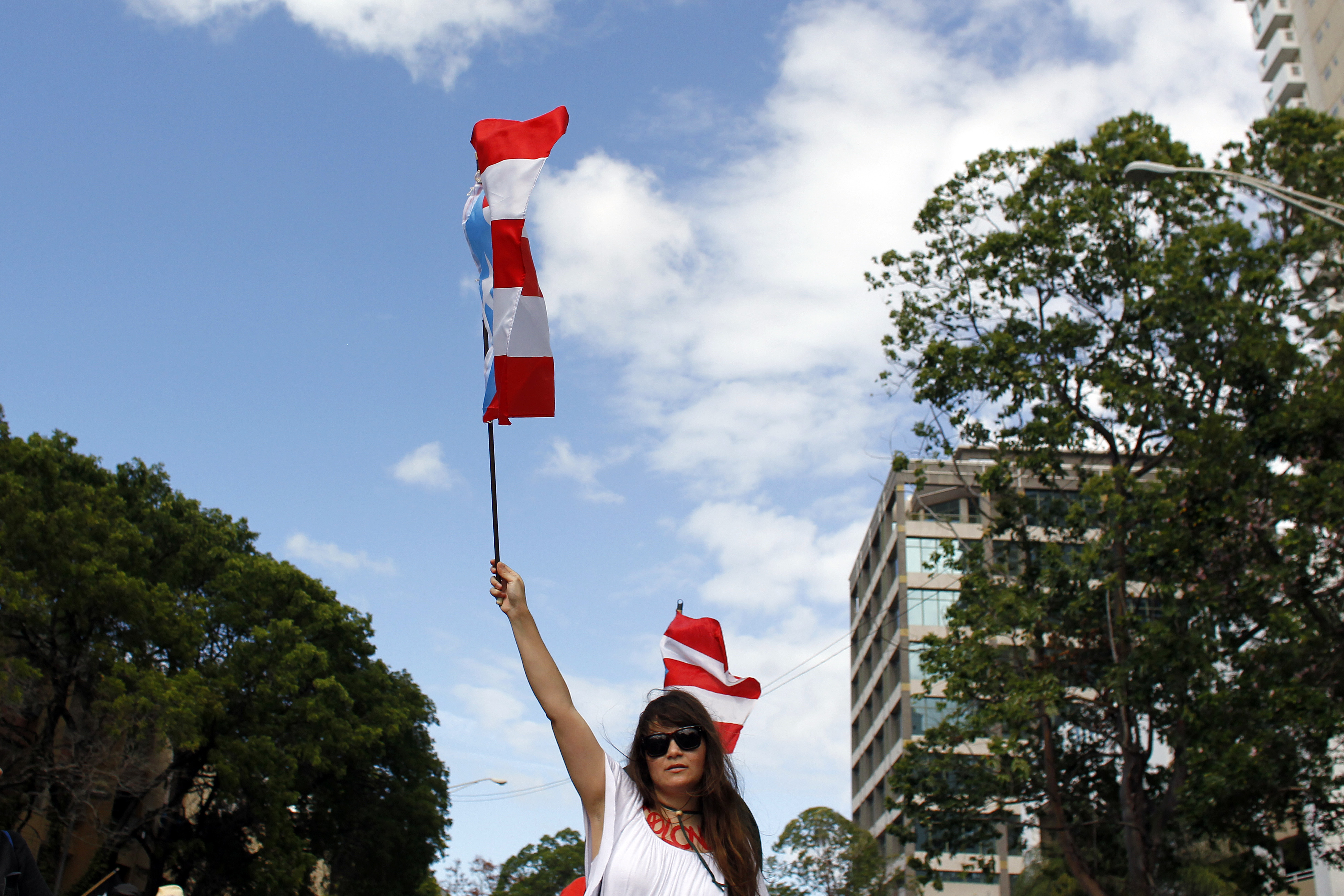 A woman waves a Puerto Rican flag during a protest against the referendum over Puerto Rico’s political status in San Juan, on June 11, 2017.