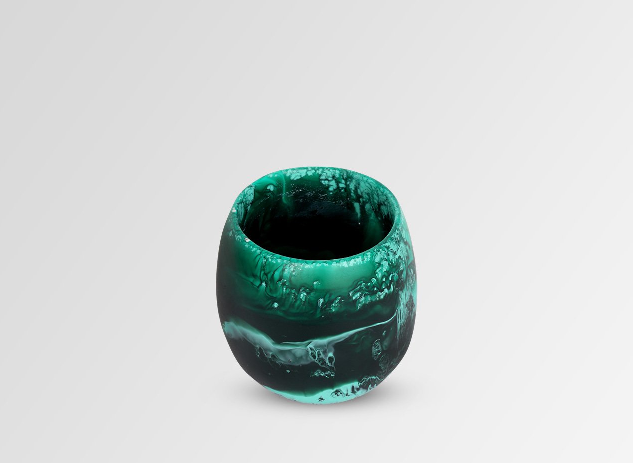 A green, swirl-patterned water glass